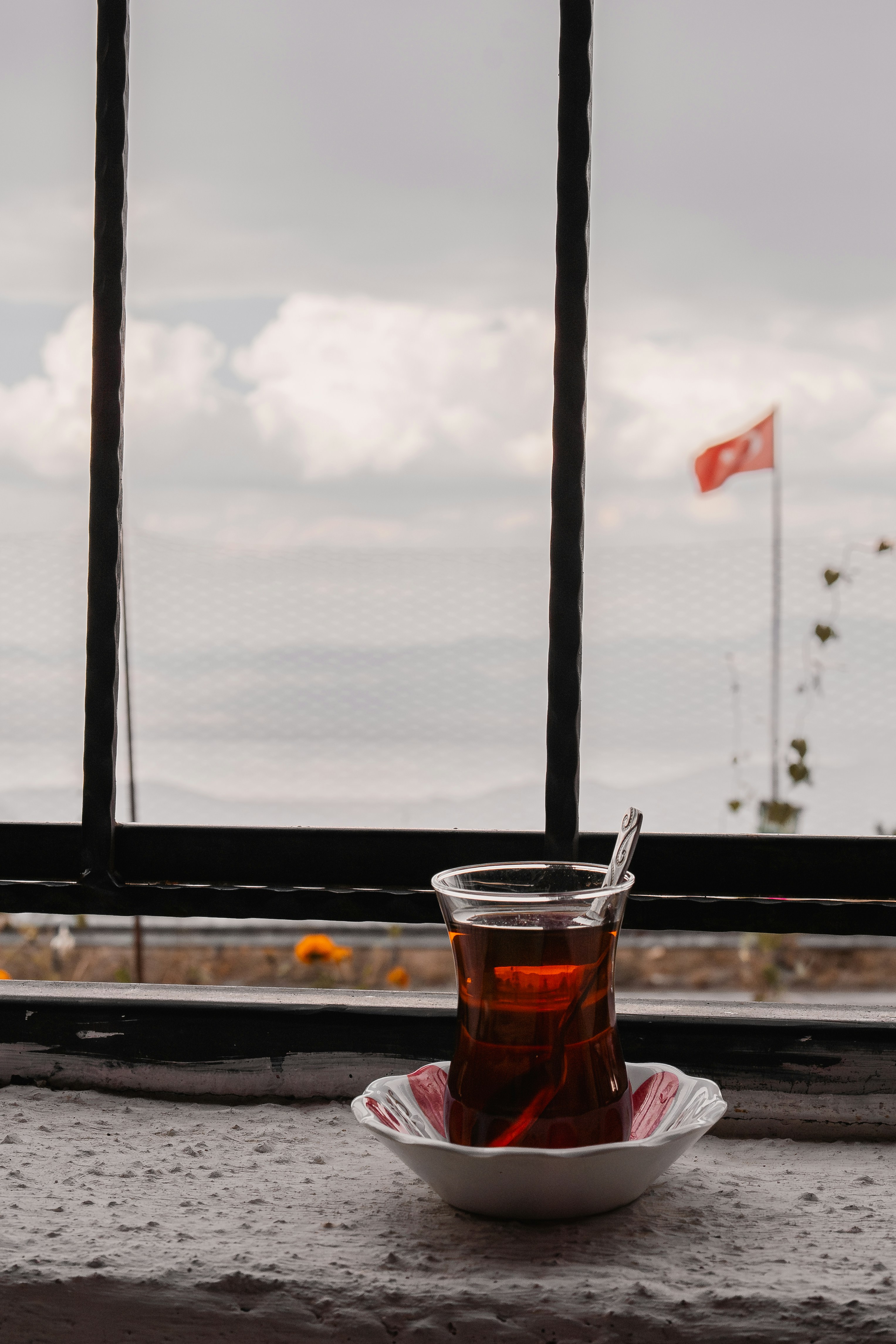 A cup of tea sitting on a table next to a window