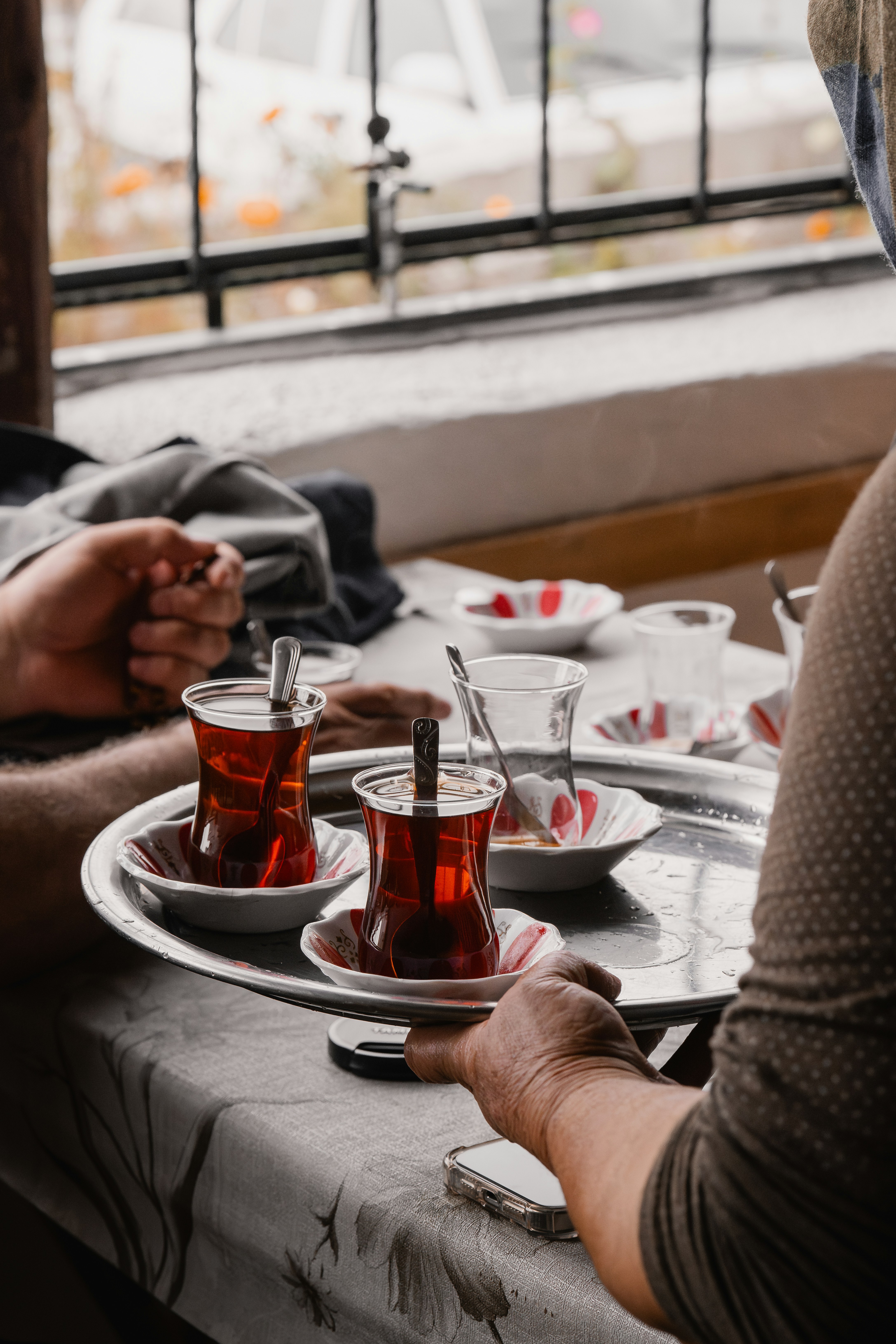 A couple of people sitting at a table with plates of food