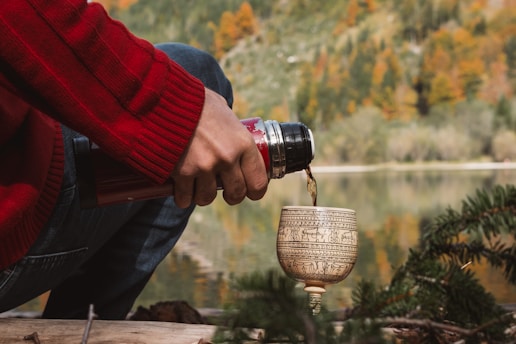 A person is pouring water into a cup