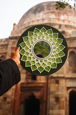 A person holding a paper plate with a circular design on it