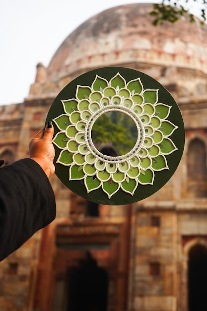 A person holding a paper plate with a circular design on it
