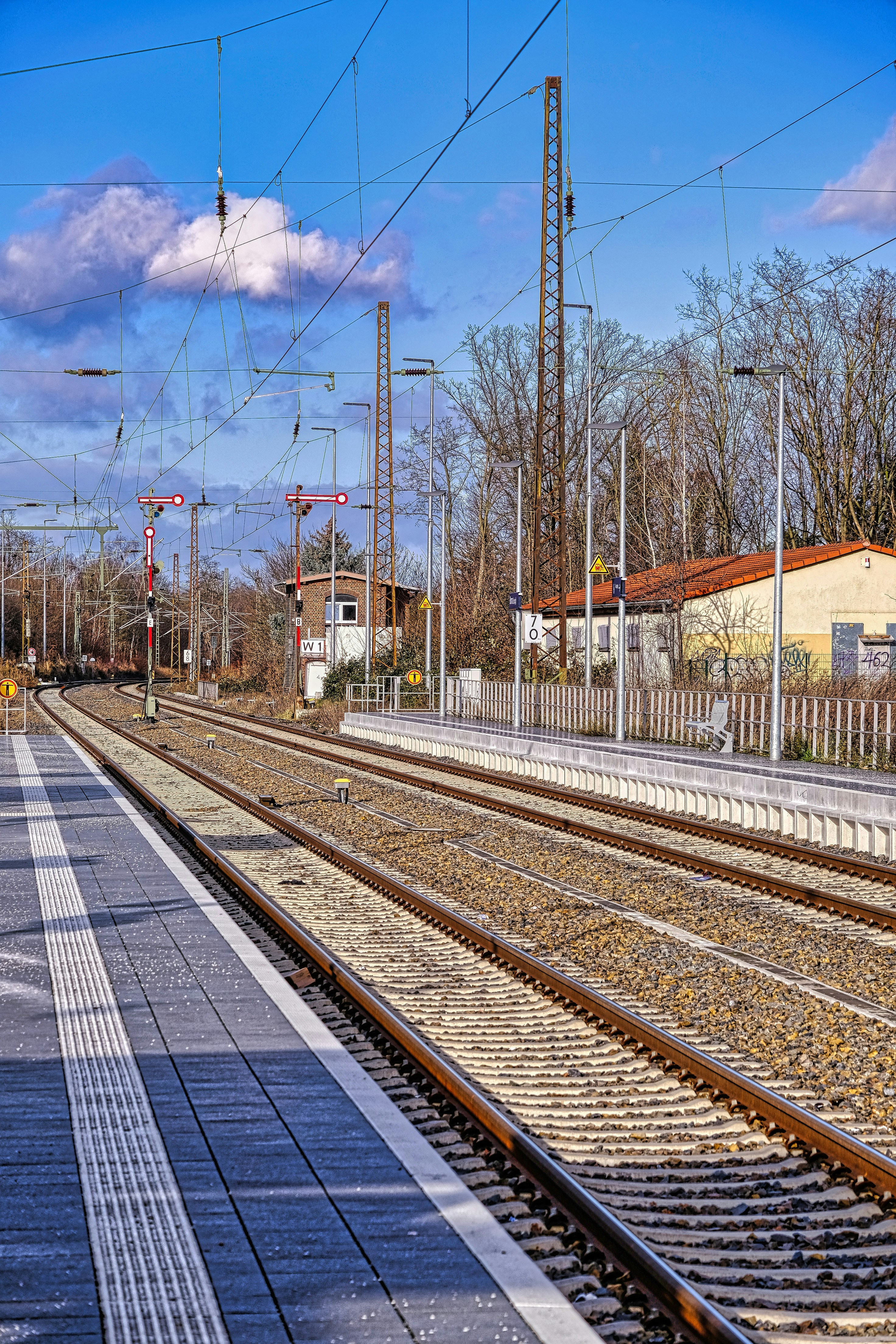 A train station with a train on the tracks