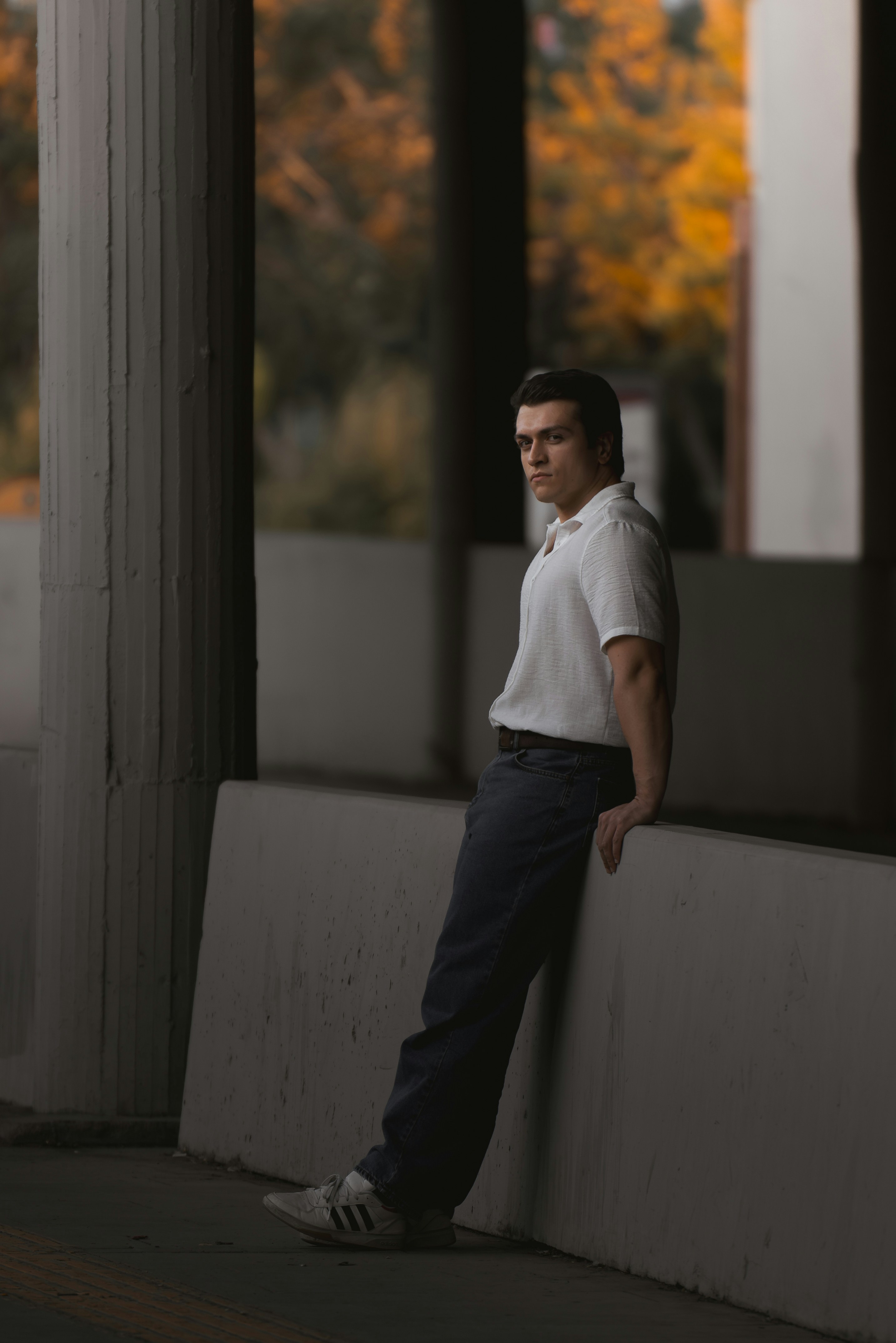 A man leaning against a wall with his hands on his hips photo – Free ...