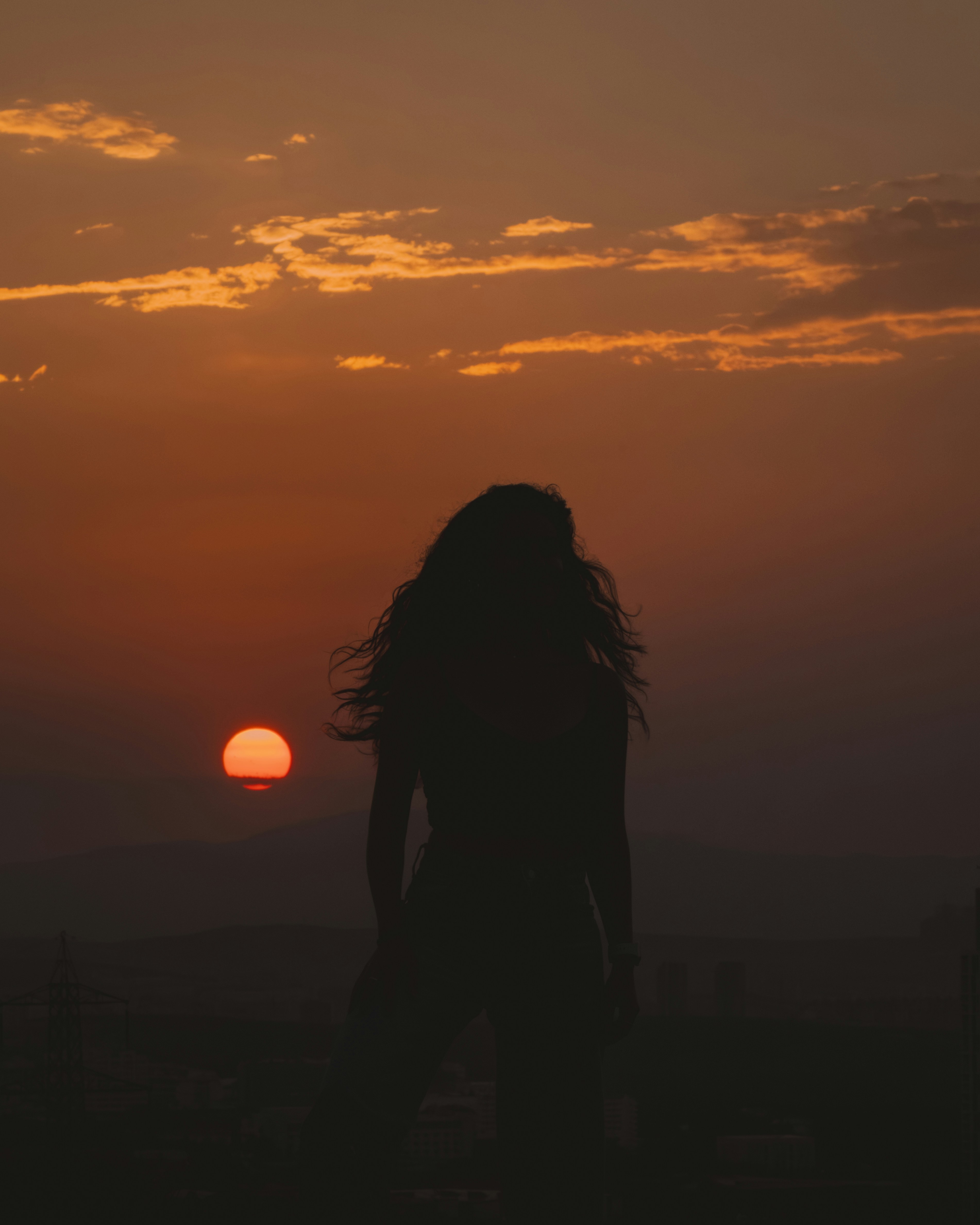 A silhouette of a woman standing in front of a sunset photo – Free ...