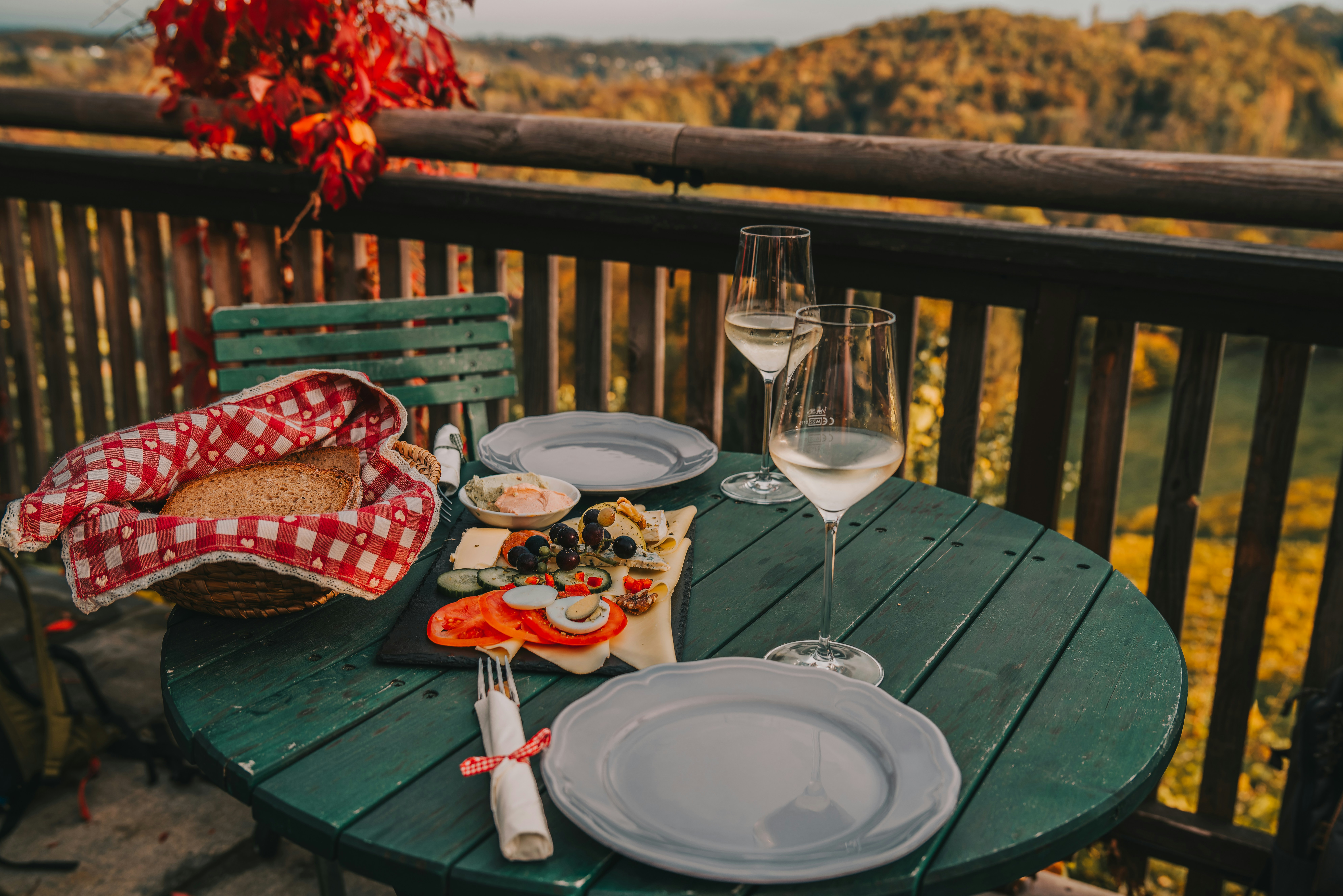 A table with plates and silverware on a deck