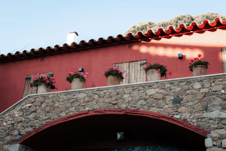 A red building with flowers on the windows