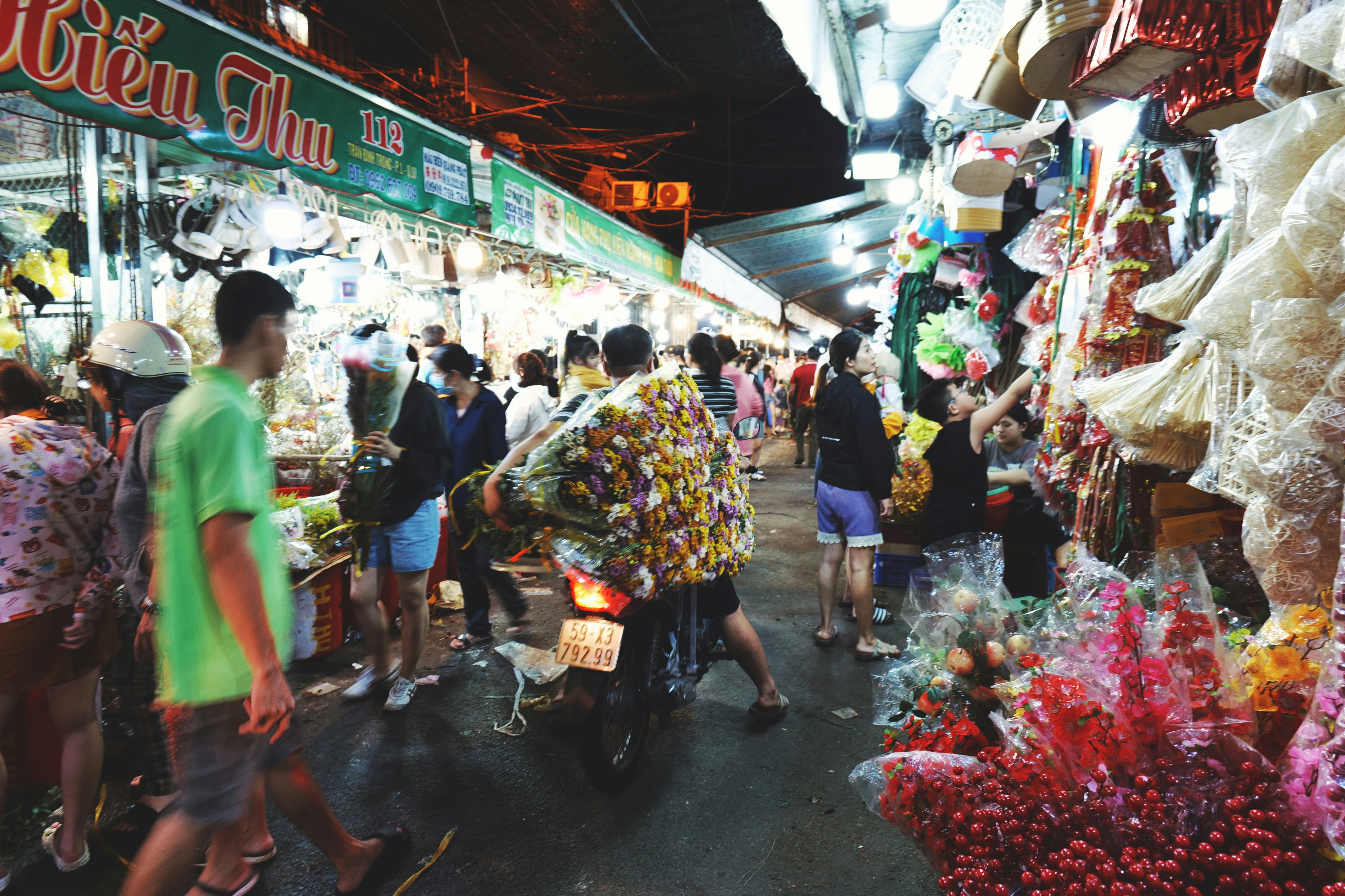 A group of people walking around a market