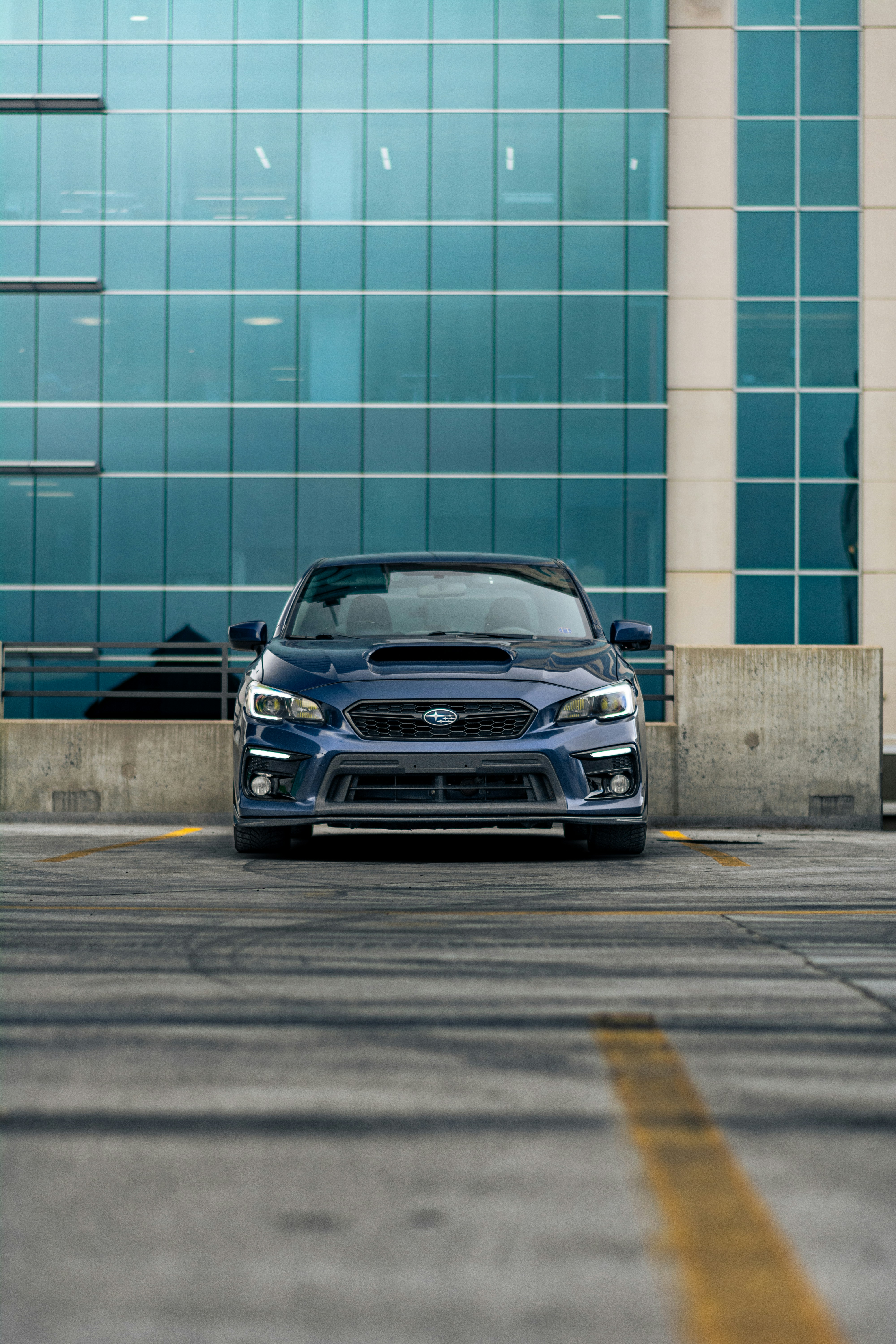 A person working on a laptop in a modern garage.