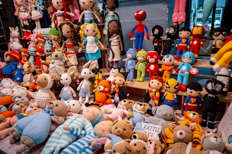 A pile of stuffed animals sitting on top of a floor