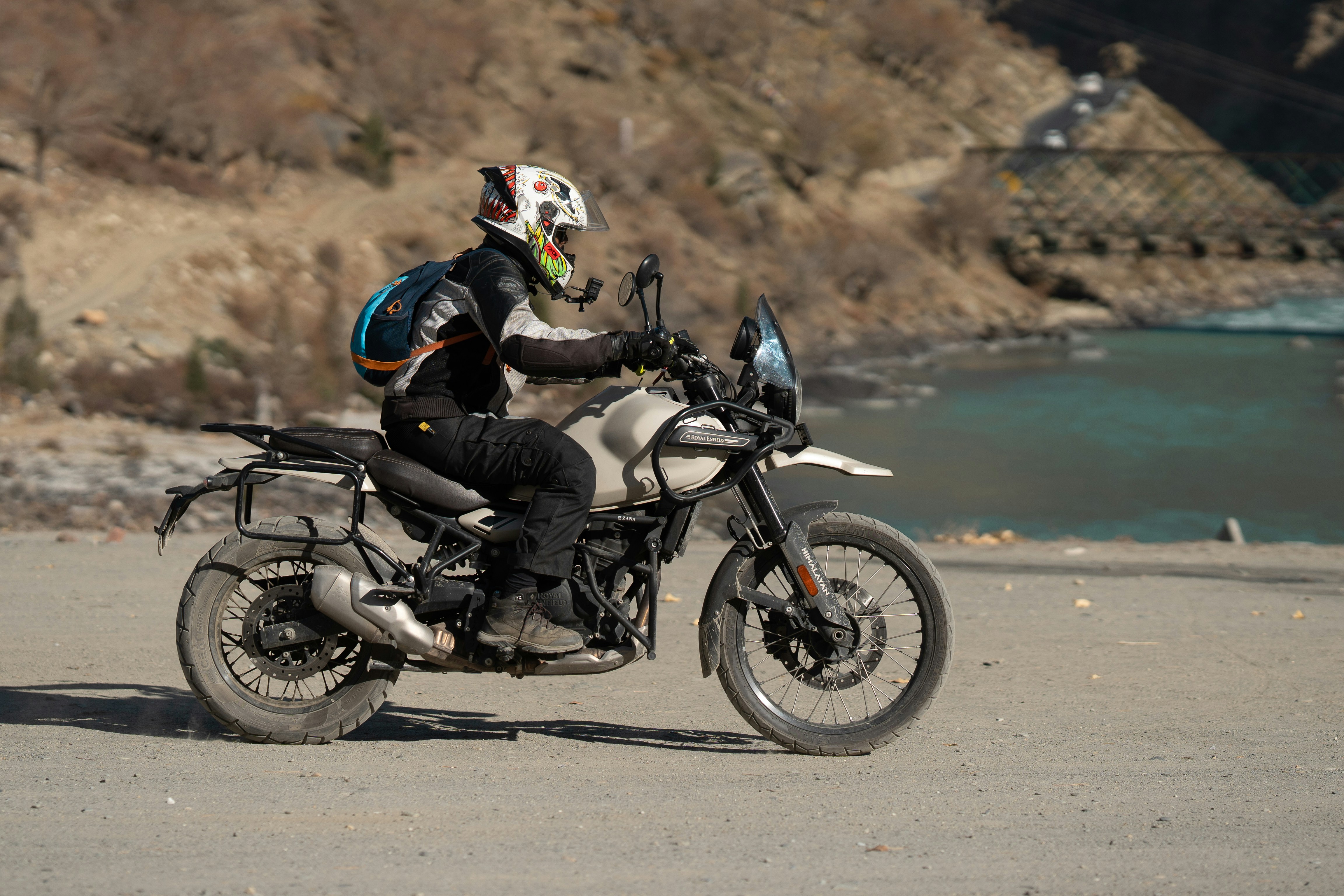 A man riding a motorcycle down a dirt road