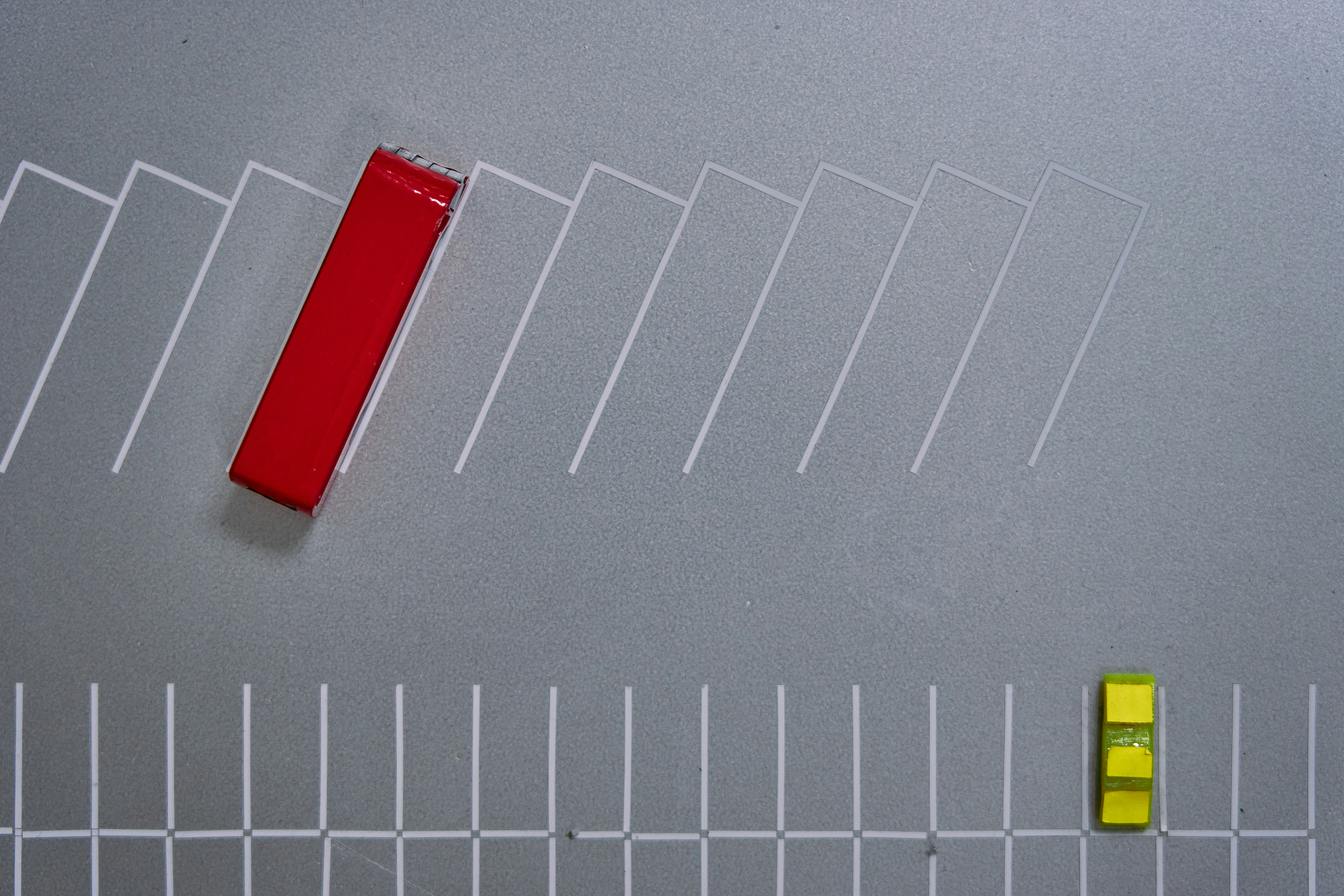 A red object is sitting on a gray surface