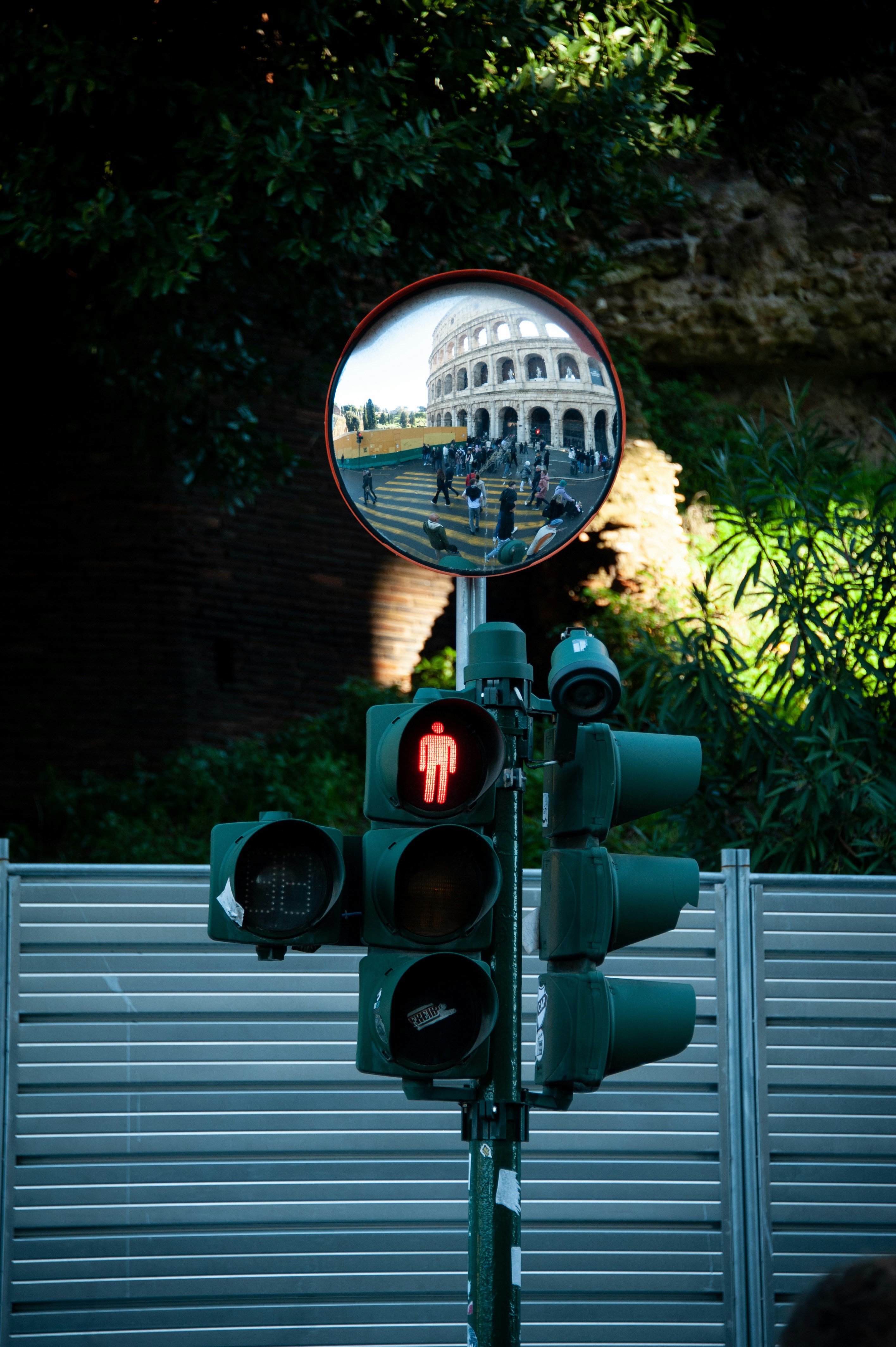 A traffic light with a reflection of a building in the mirror photo ...