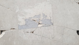 A close up of a piece of cement with a crack in it