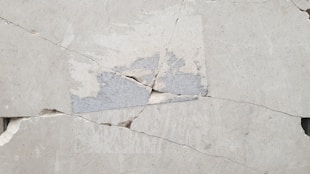 A close up of a piece of cement with a crack in it