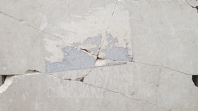 A close up of a piece of cement with a crack in it