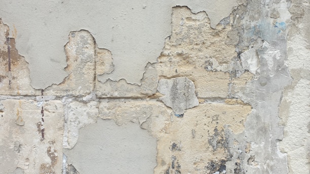 A close up of a wall with peeling paint