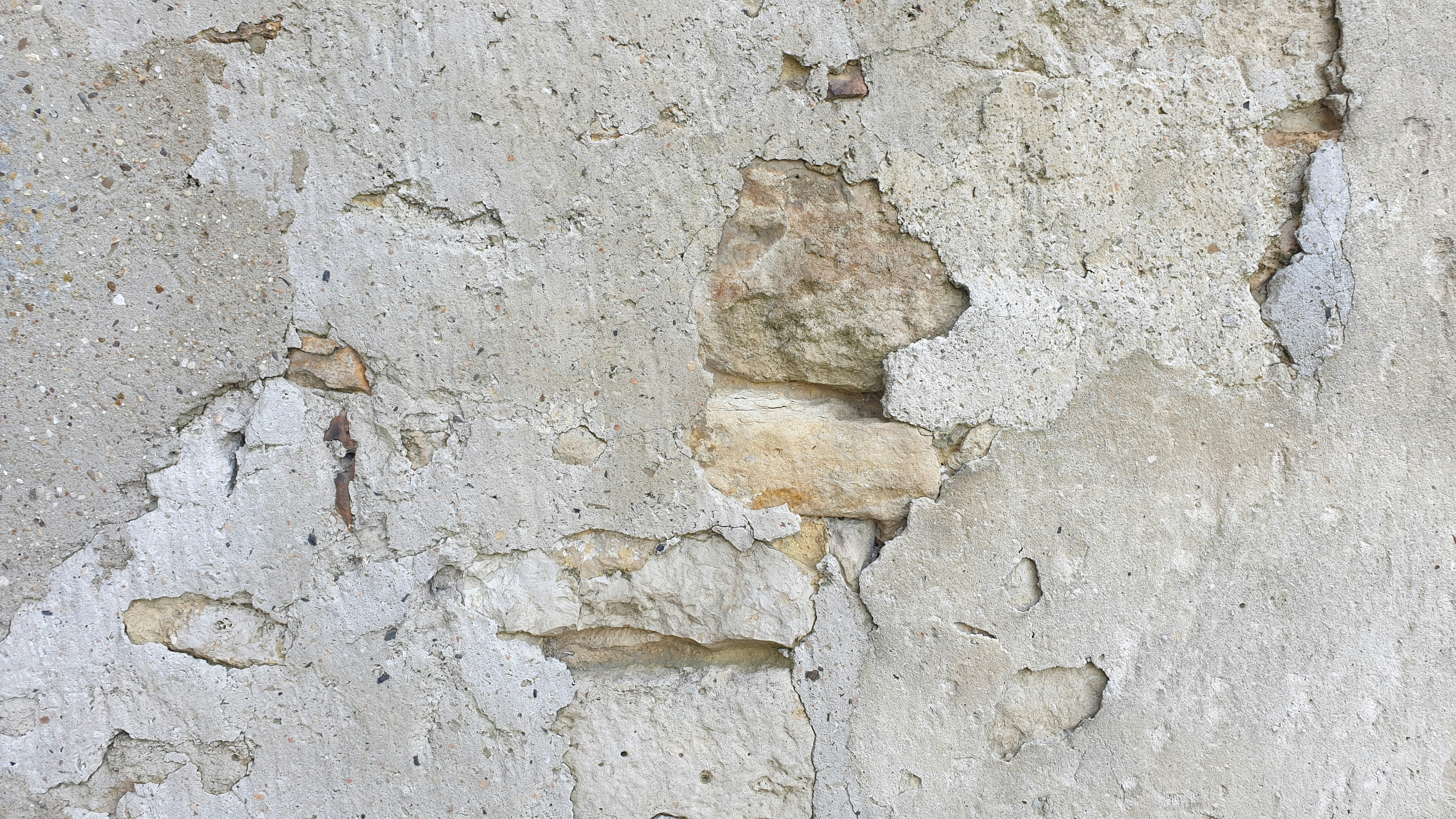 A close up of a wall with peeling paint
