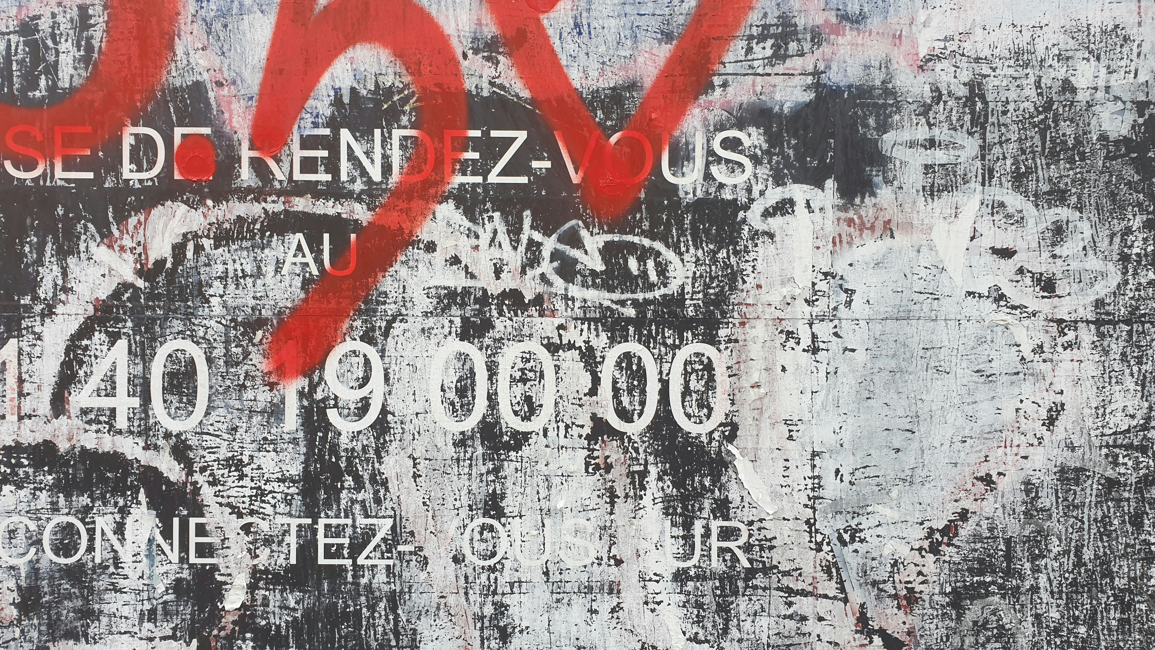 A painting with a red spray paint on it