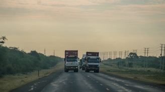 A couple of trucks that are on a road