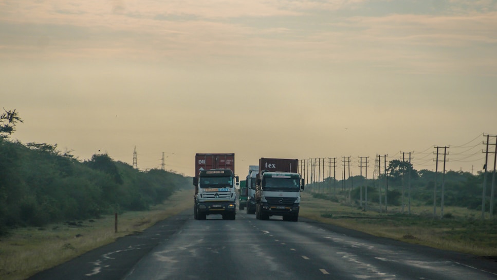 A couple of trucks that are on a road