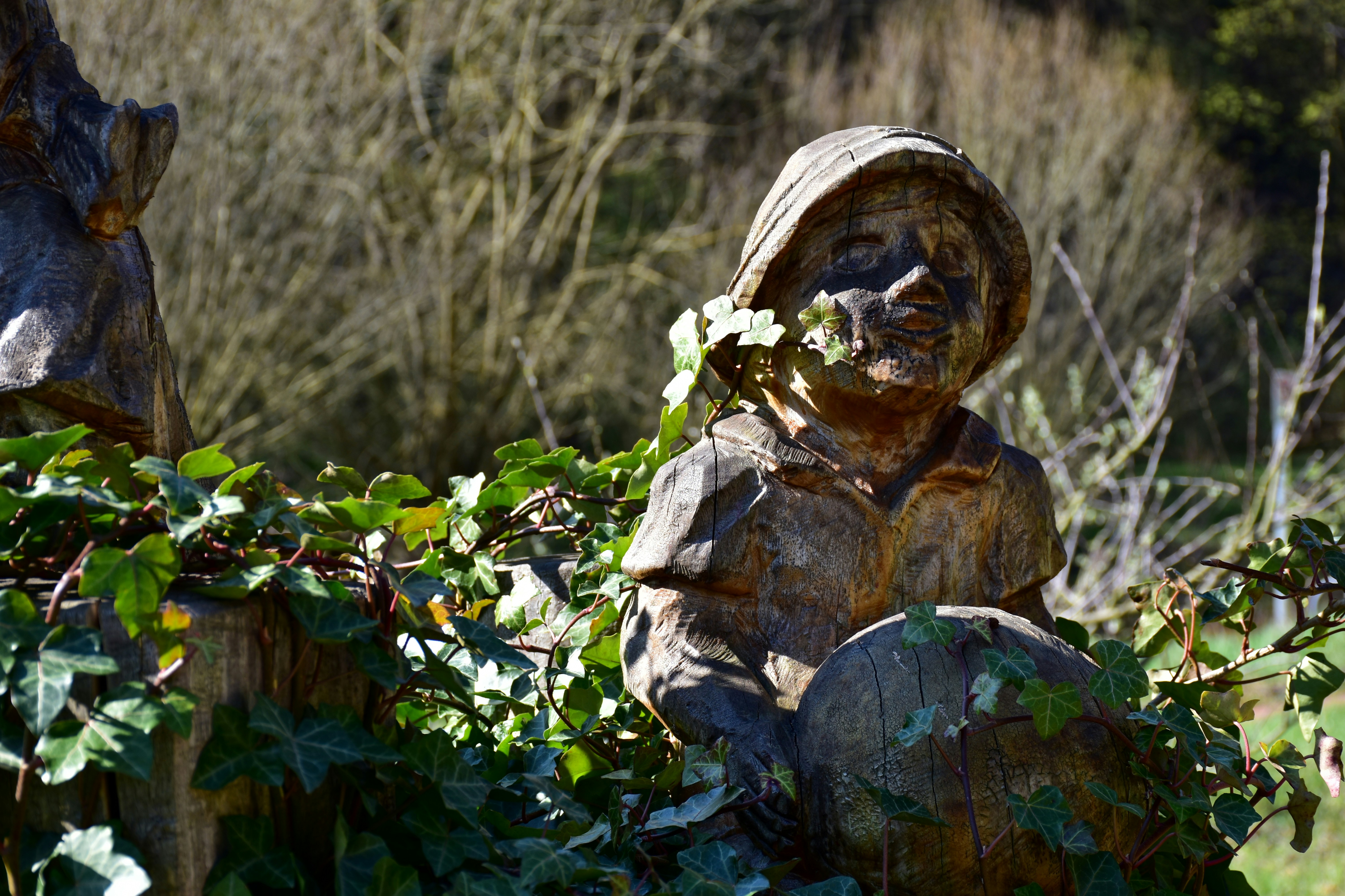 A statue of a person sitting on a rock