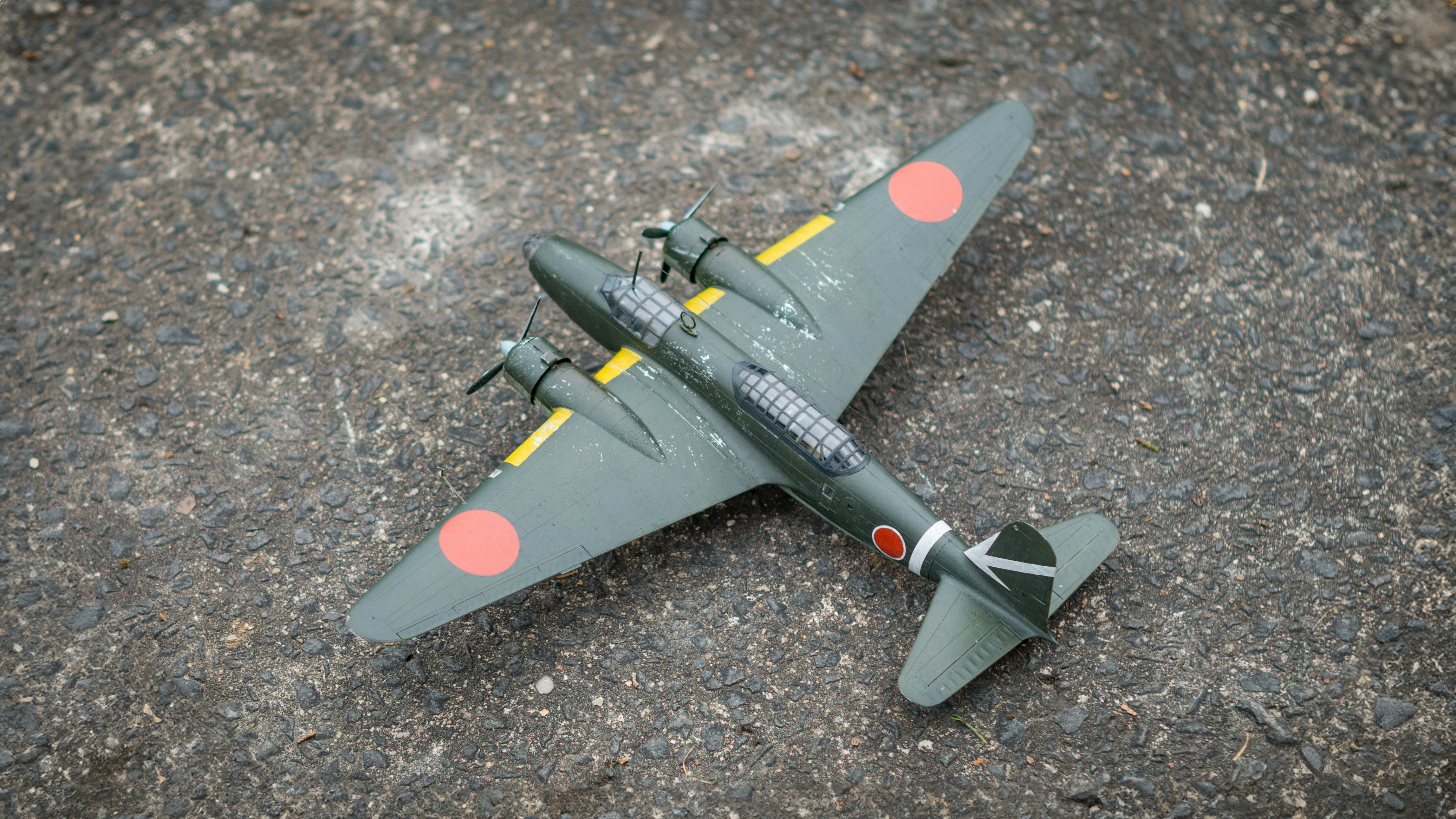 A toy airplane is laying on the ground