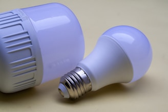 A close up of two light bulbs on a table