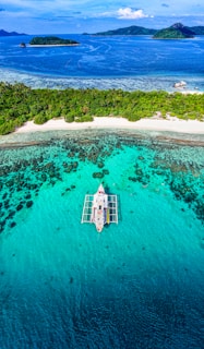 An aerial view of a boat in the ocean