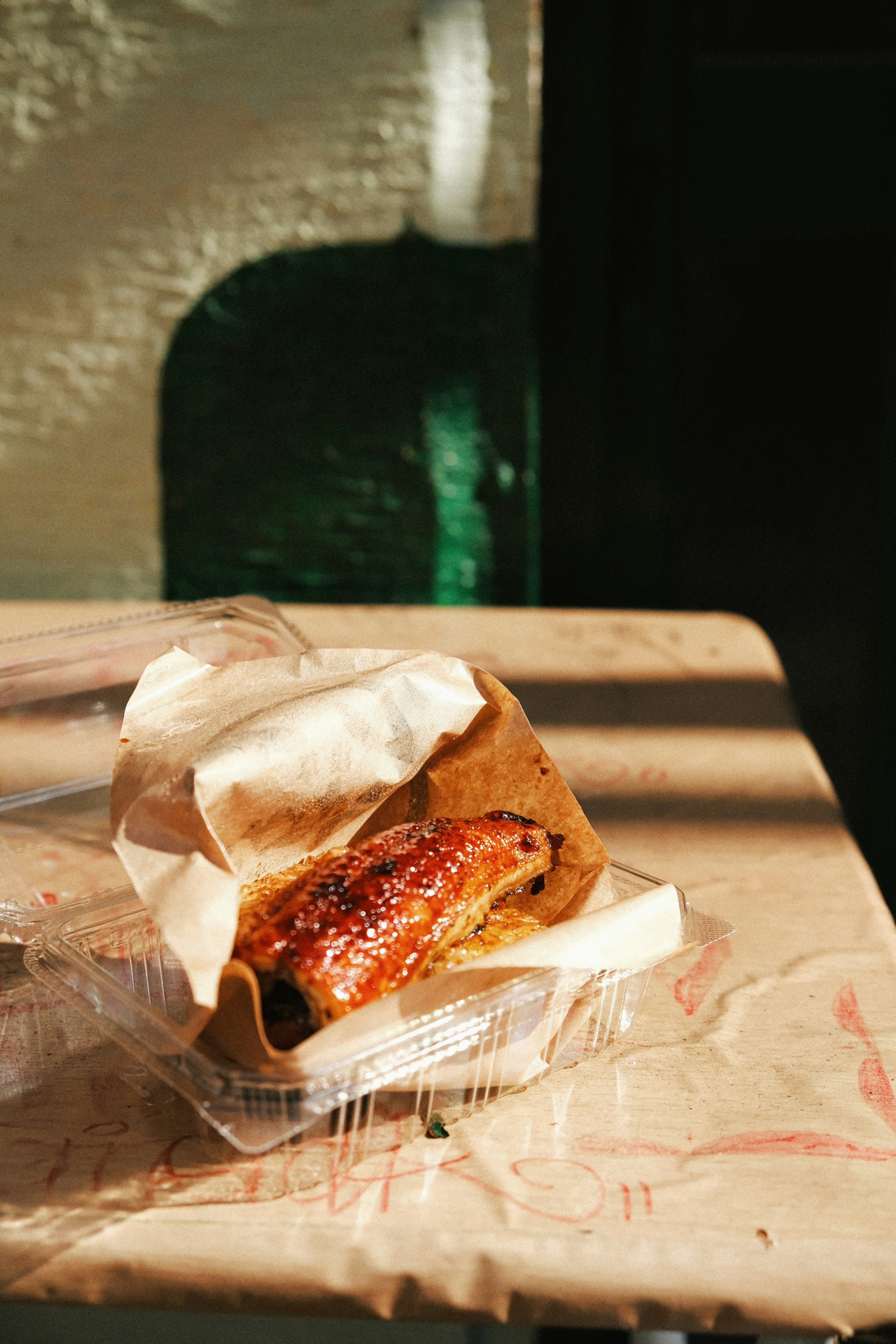 A hot dog sitting on top of a bun covered in ketchup