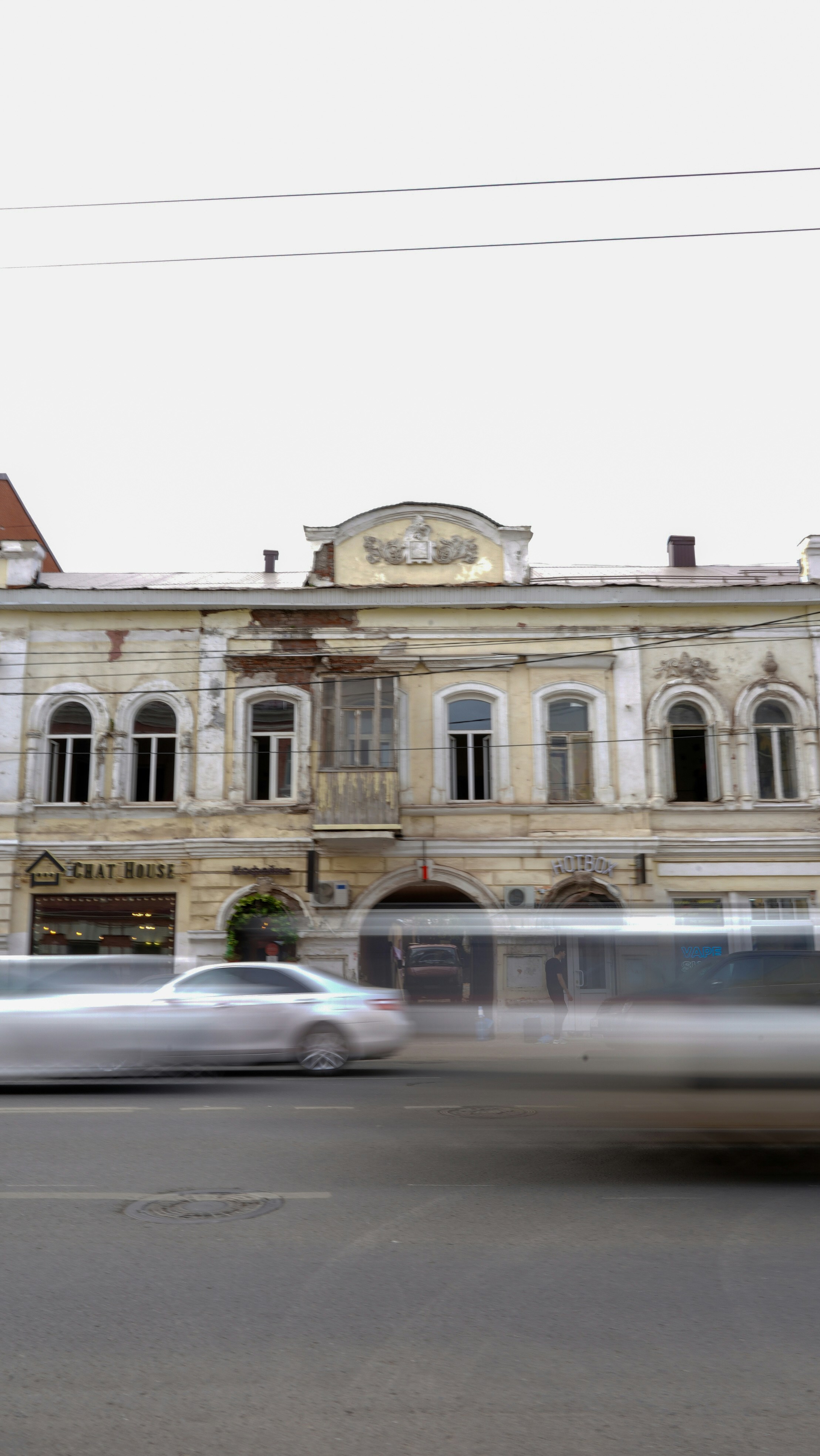 A blurry photo of a bus driving past a building