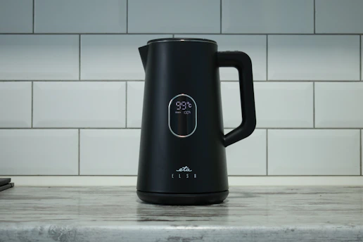 A black coffee pot sitting on top of a counter