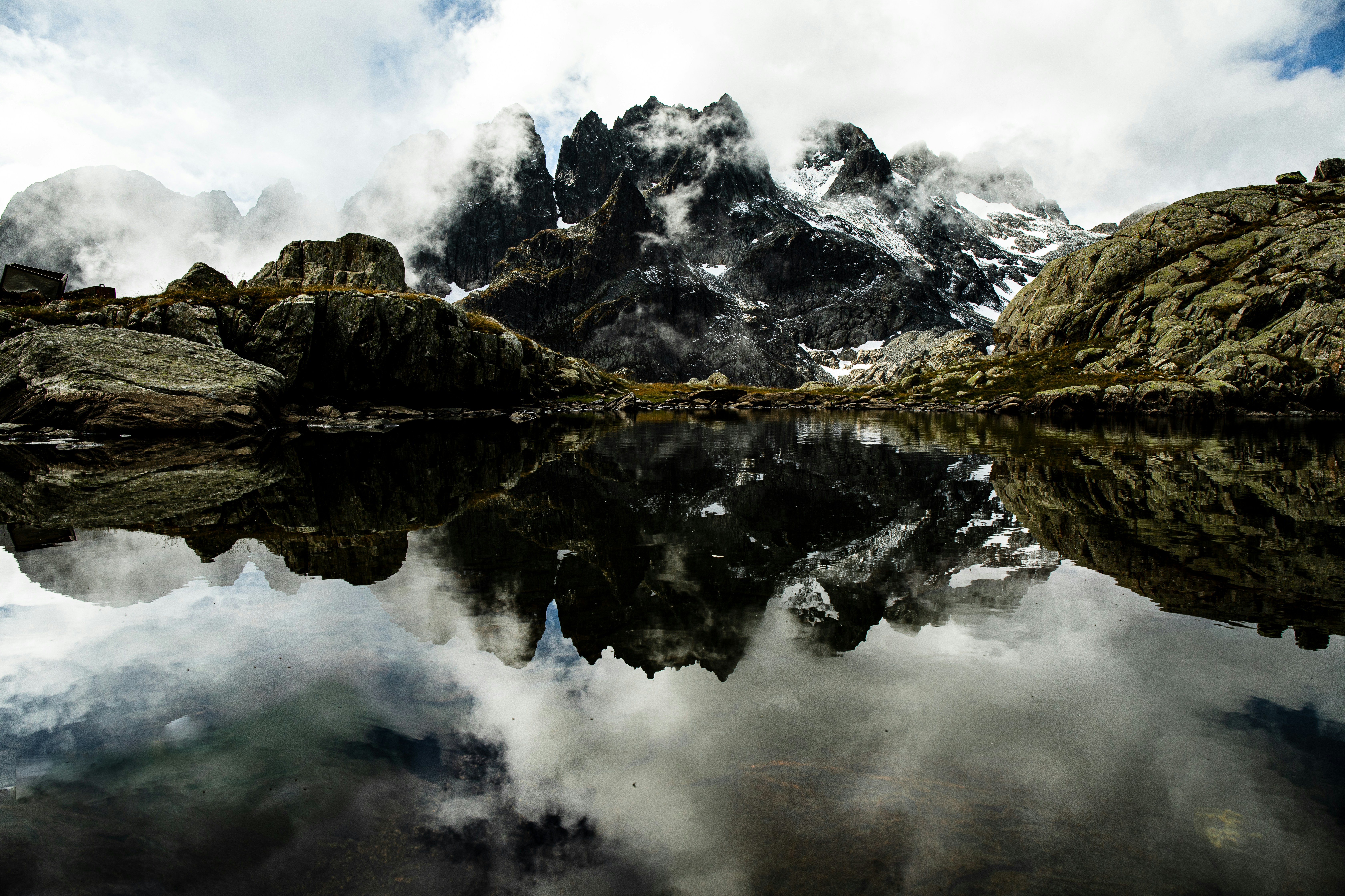 A mountain is reflected in the still water of a lake