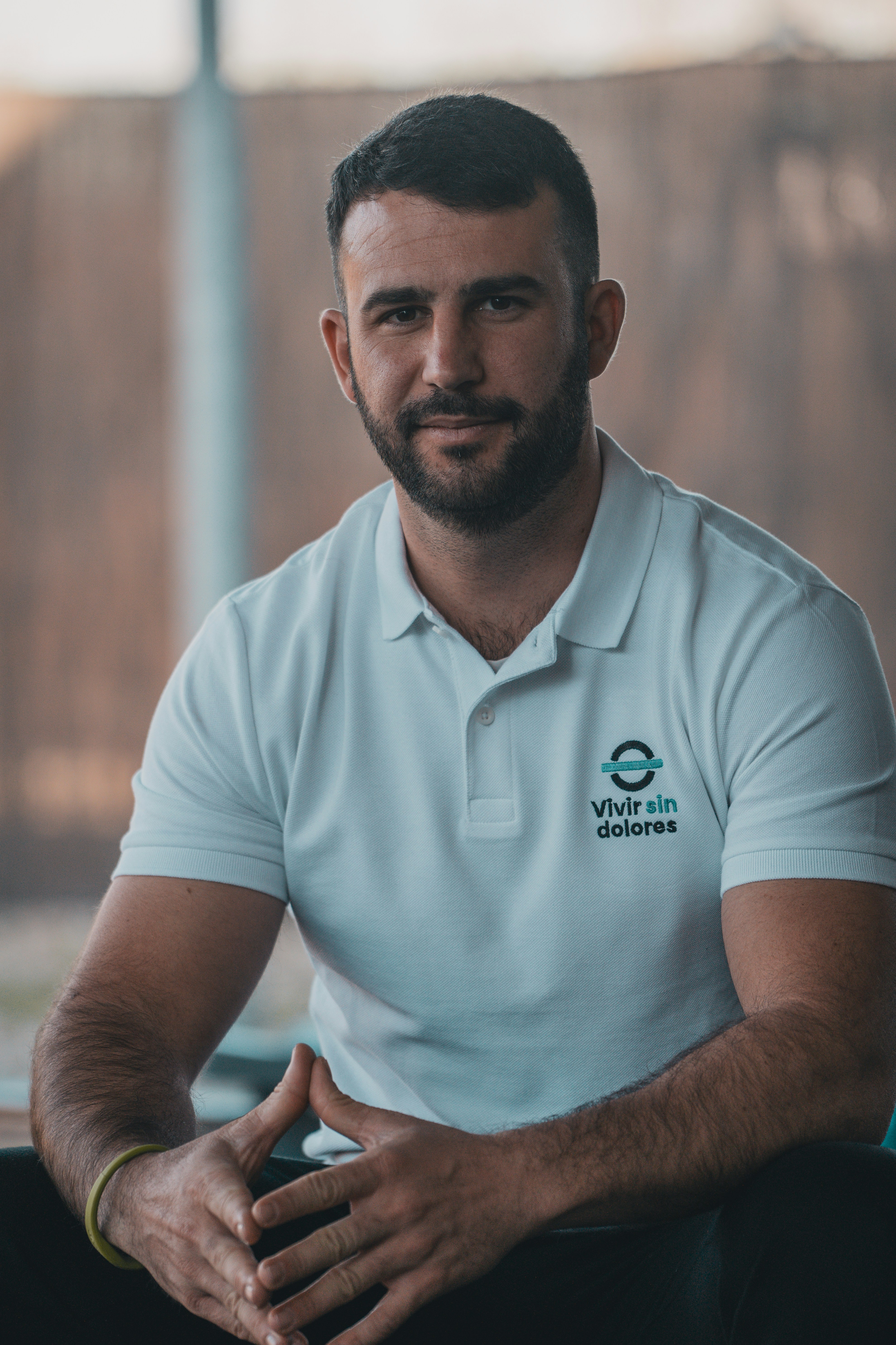 A man in a white shirt is sitting down