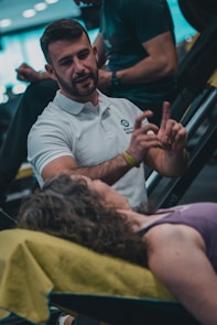 A man sitting in a chair talking to a woman