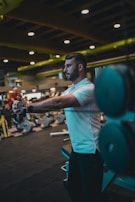 A man in a gym holding a barbell