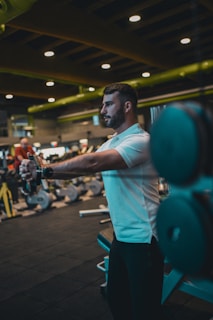 A man in a gym holding a barbell