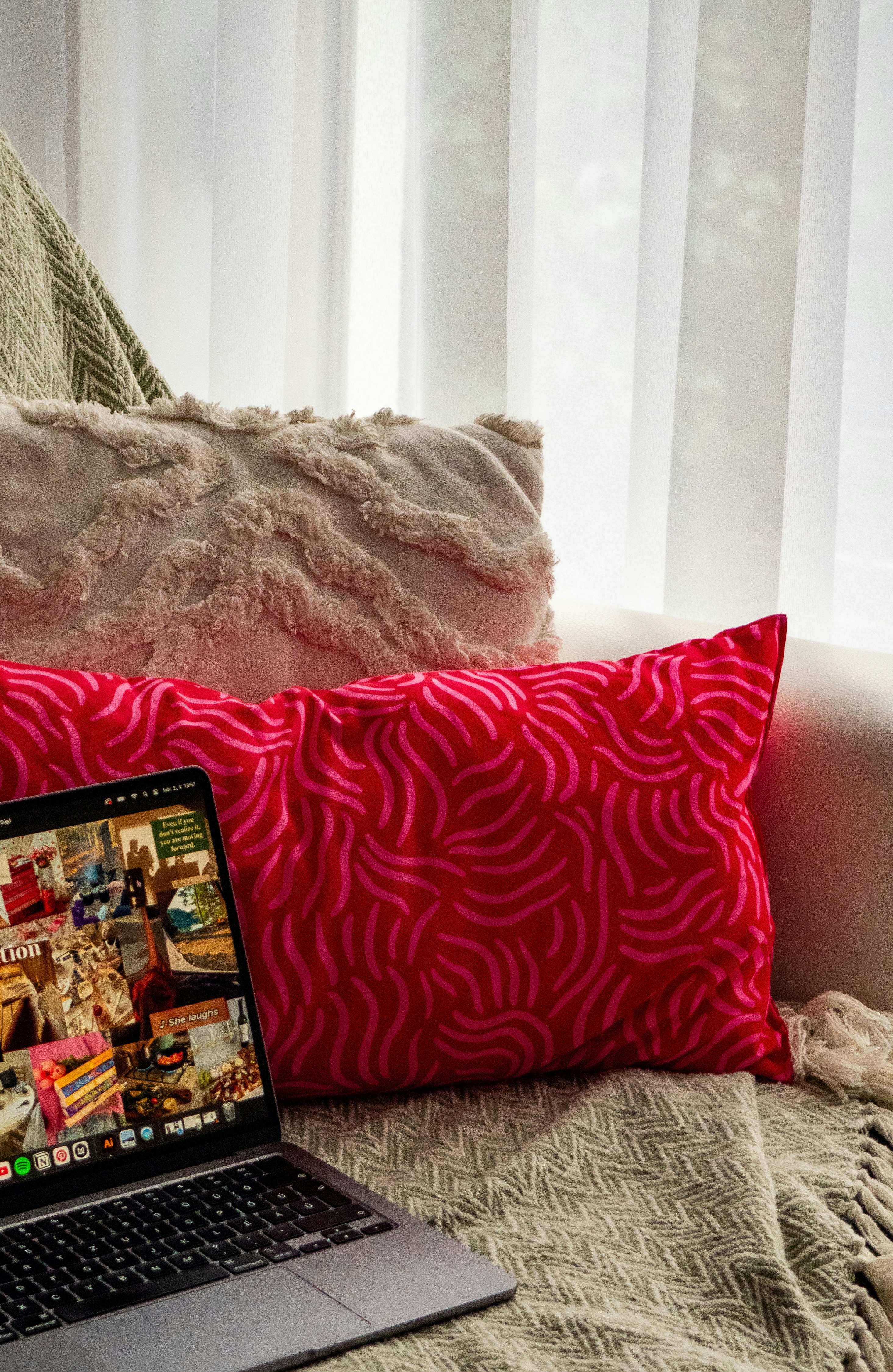 A laptop computer sitting on top of a bed