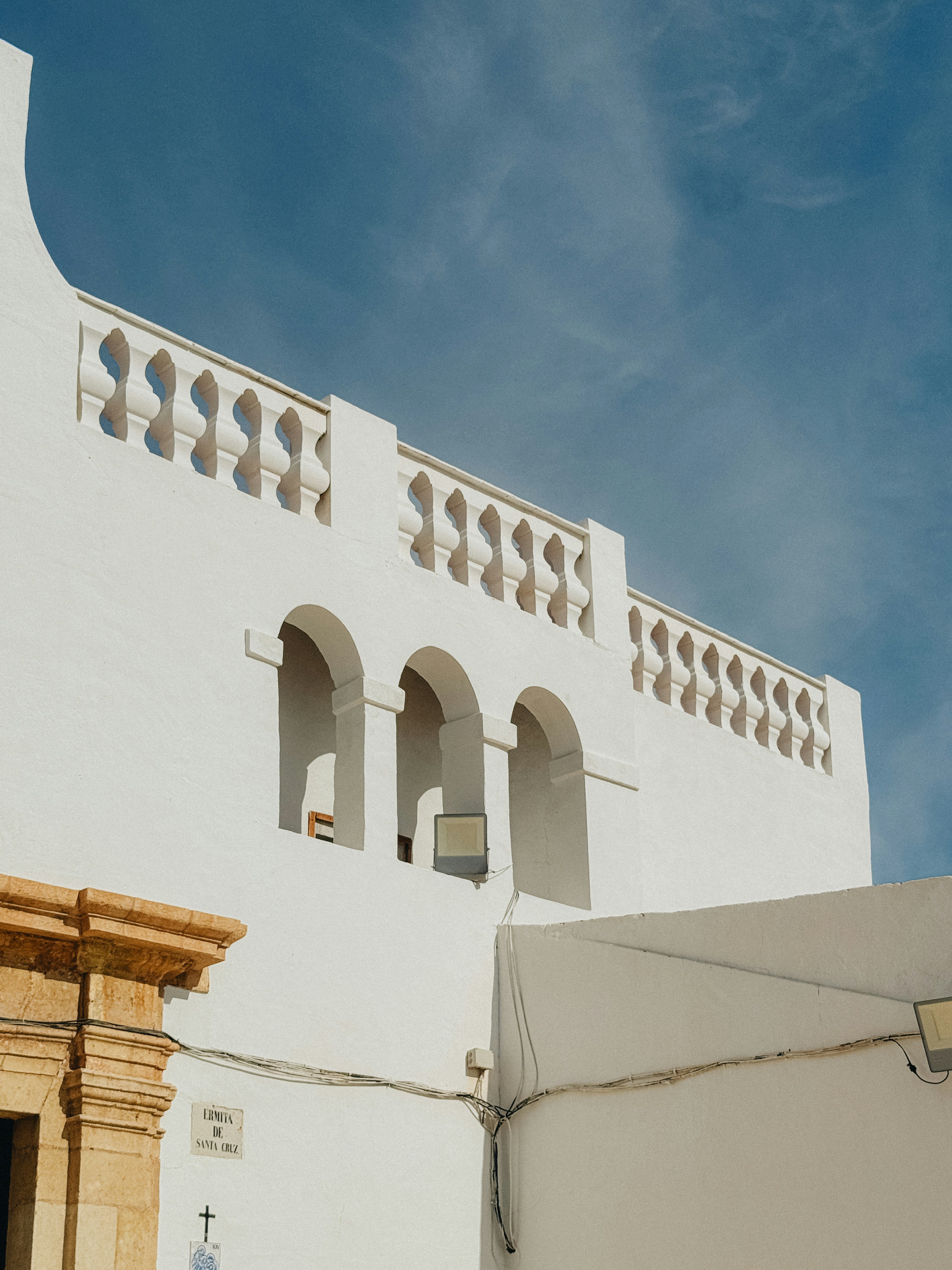 A white building with a clock on the side of it