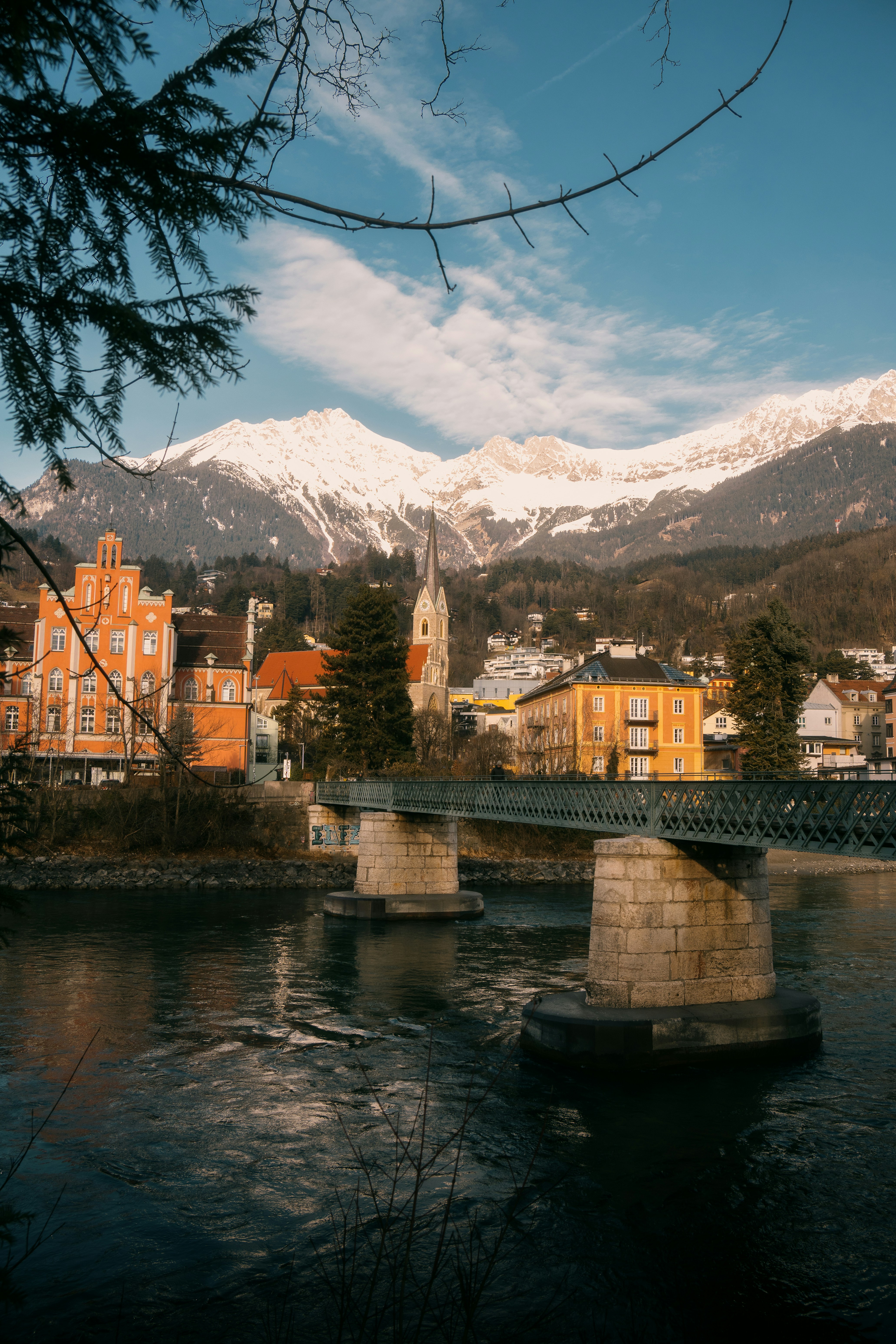 A bridge over a body of water with a mountain in the background