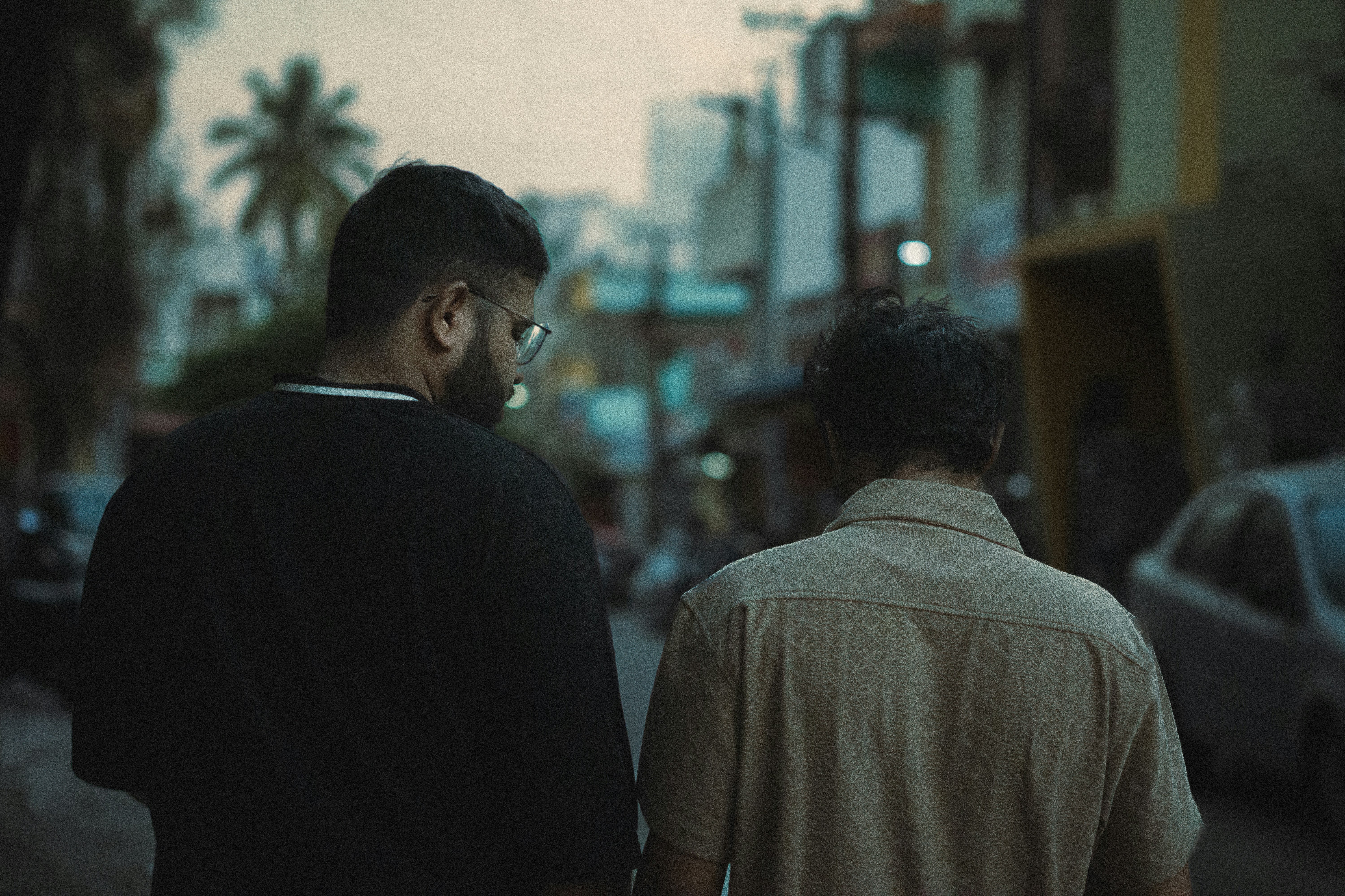 A couple of men walking down a street