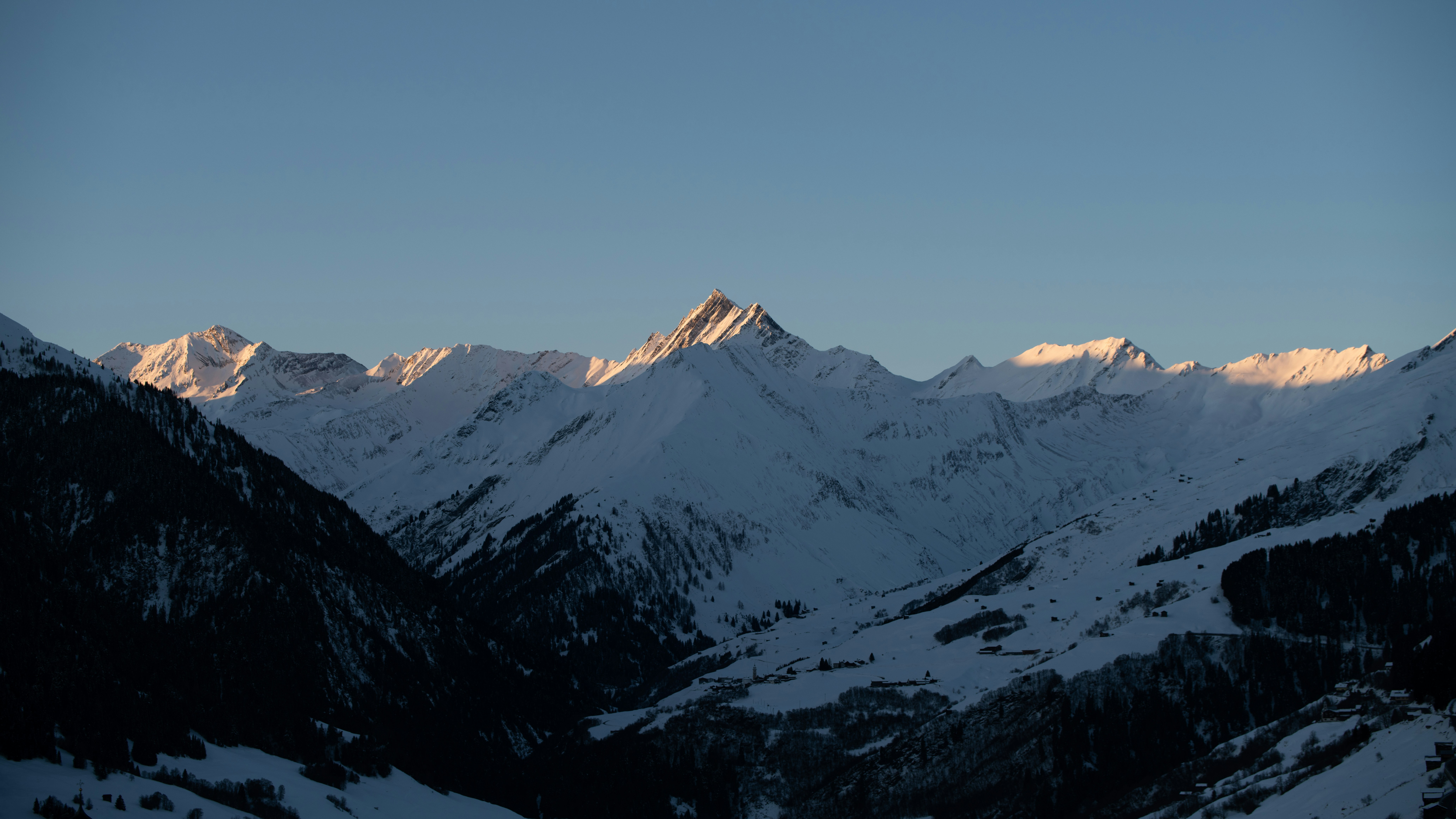 A view of a mountain range with snow on it