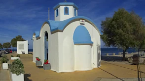 A white and blue church with a blue roof