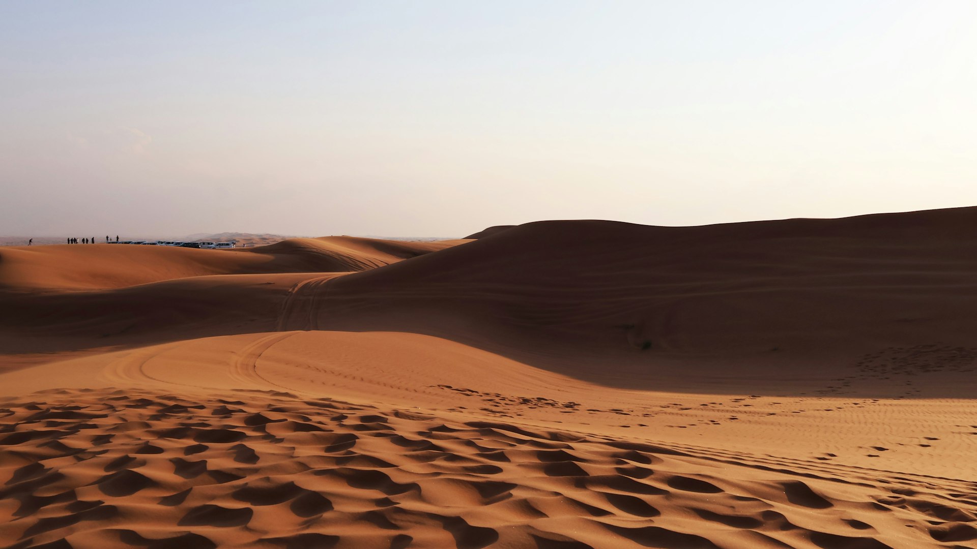 A sandy area with a few footprints in the sand