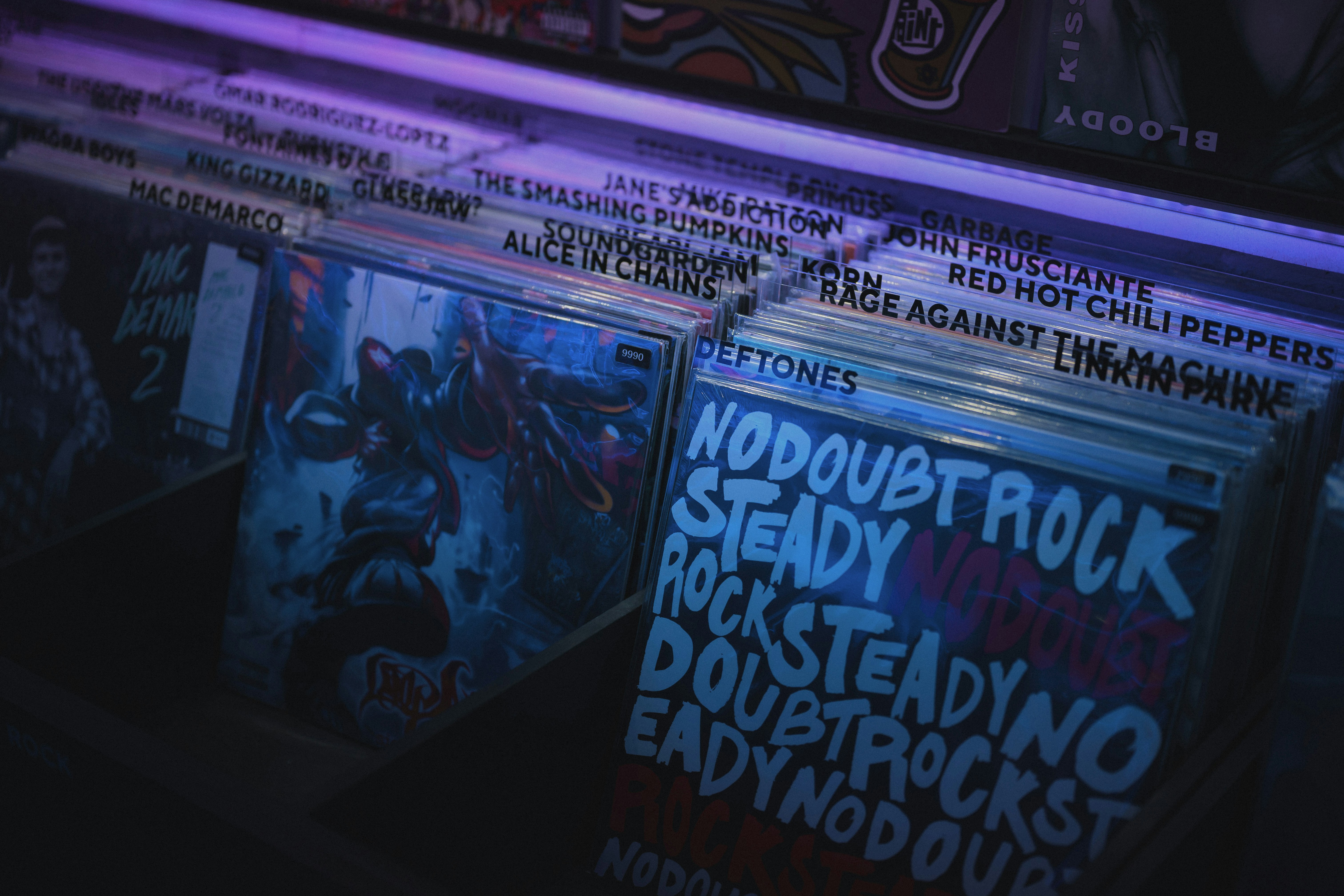A rack of cds with graffiti on them