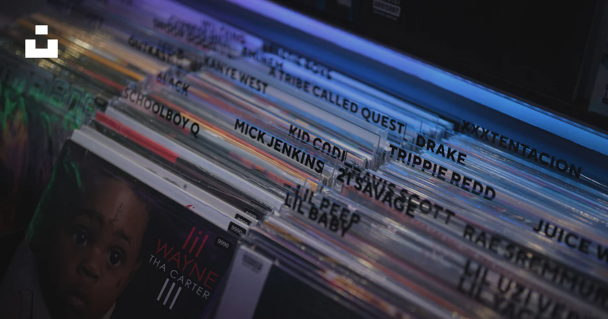 A stack of cds sitting on top of a table photo – Free Human Image on ...