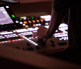 A person standing in front of a mixing board