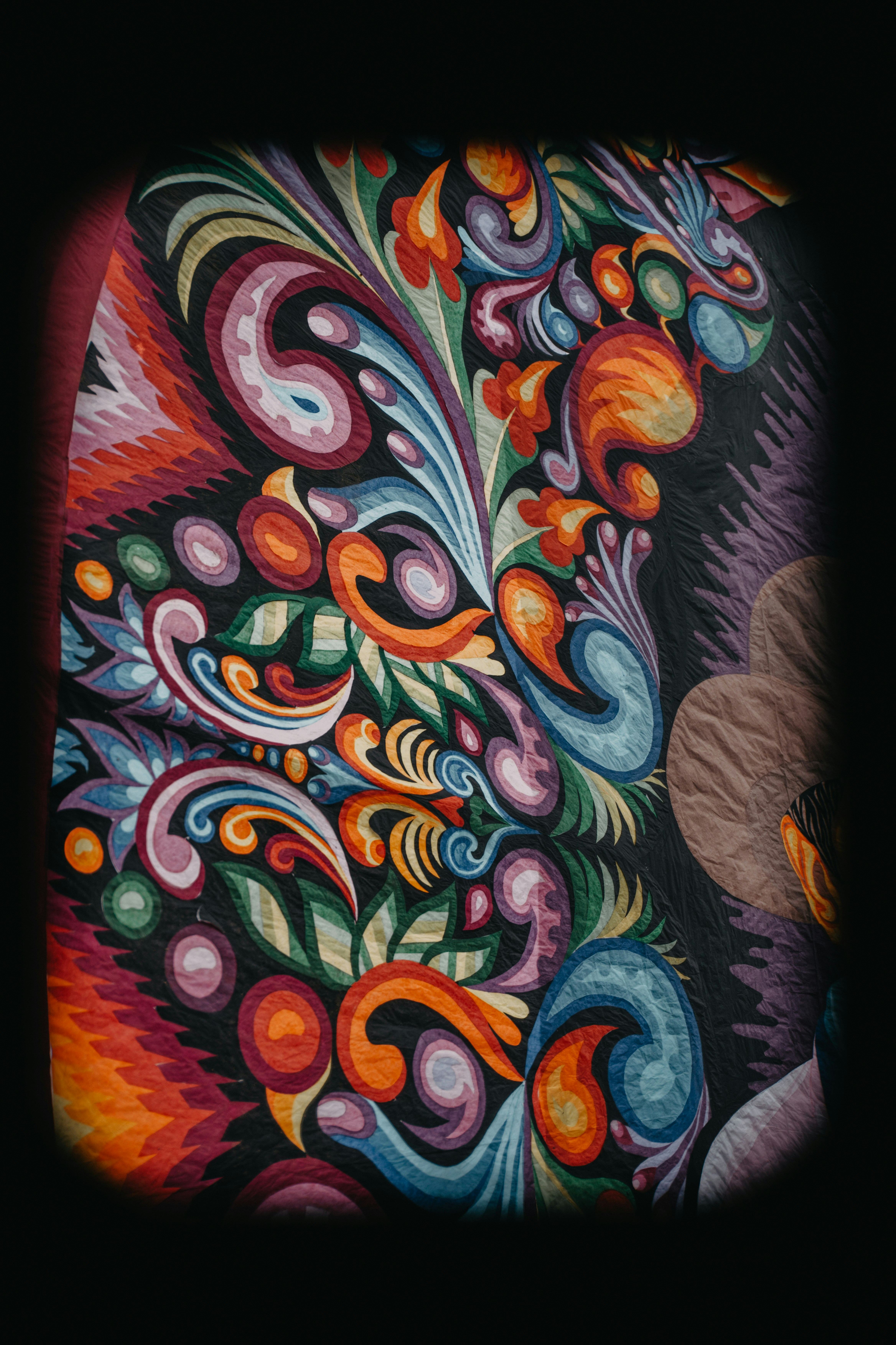 Intricate fabric with detailed paisley and floral patterns.