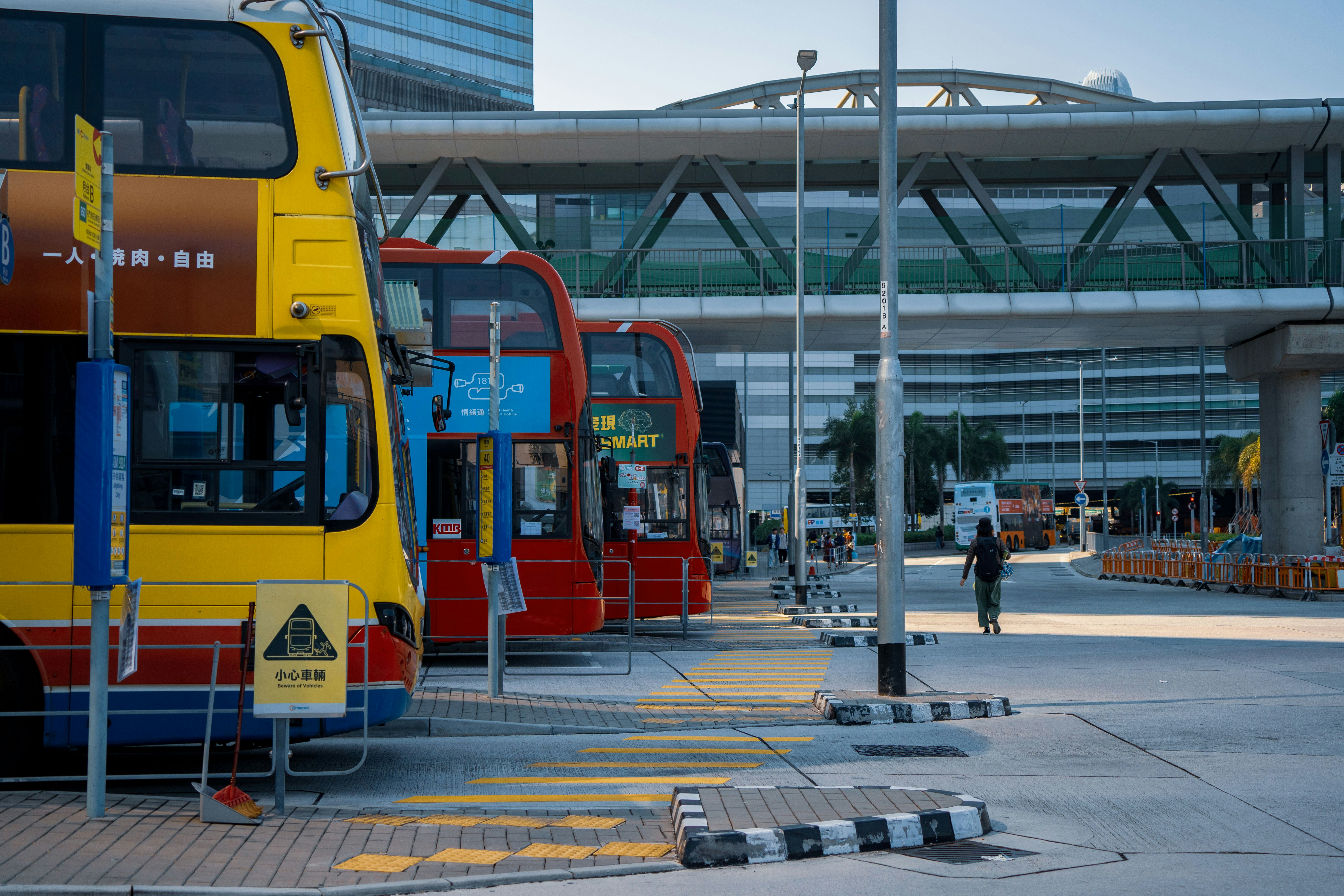 A row of double decker buses parked next to each other