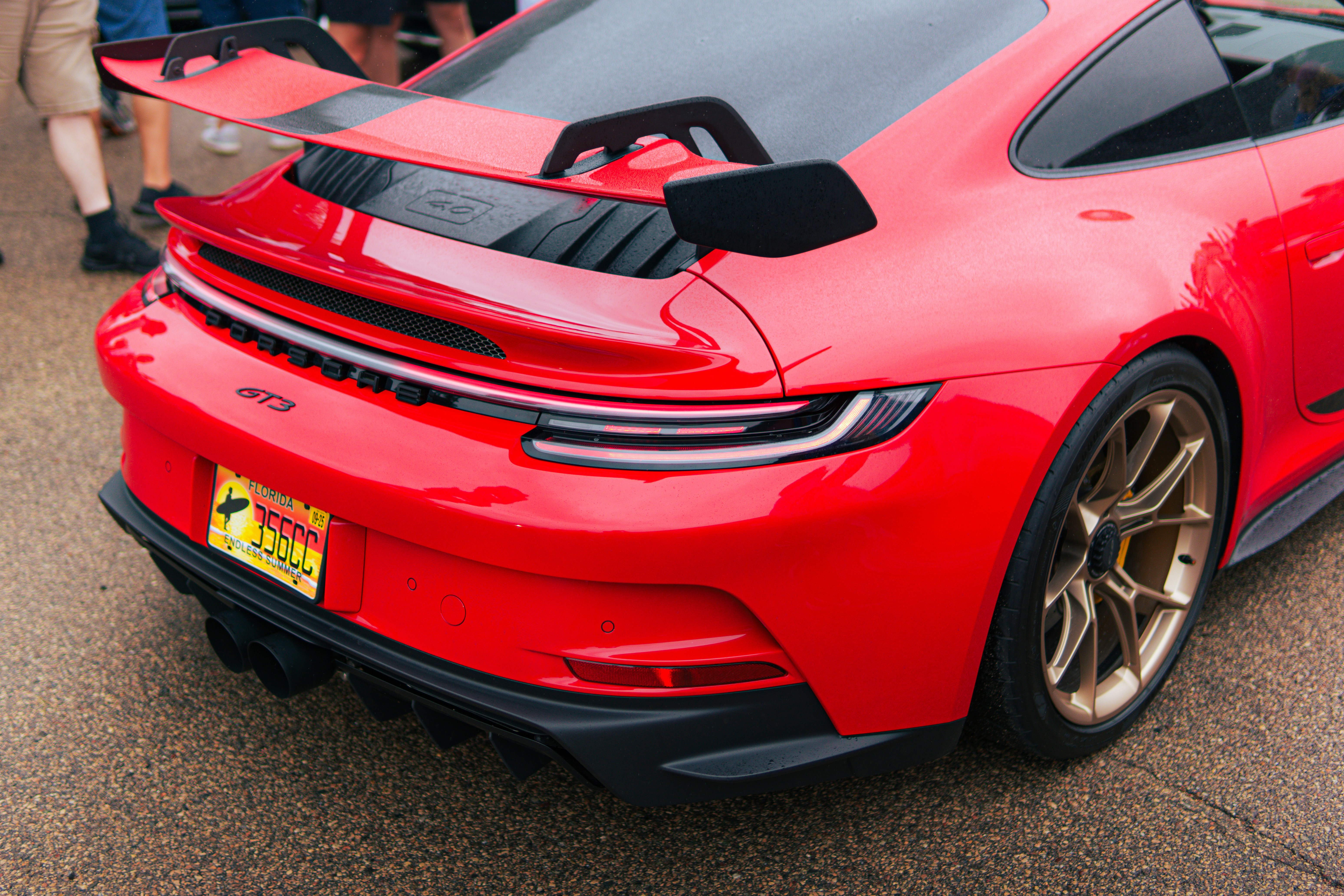 A red sports car parked in a parking lot