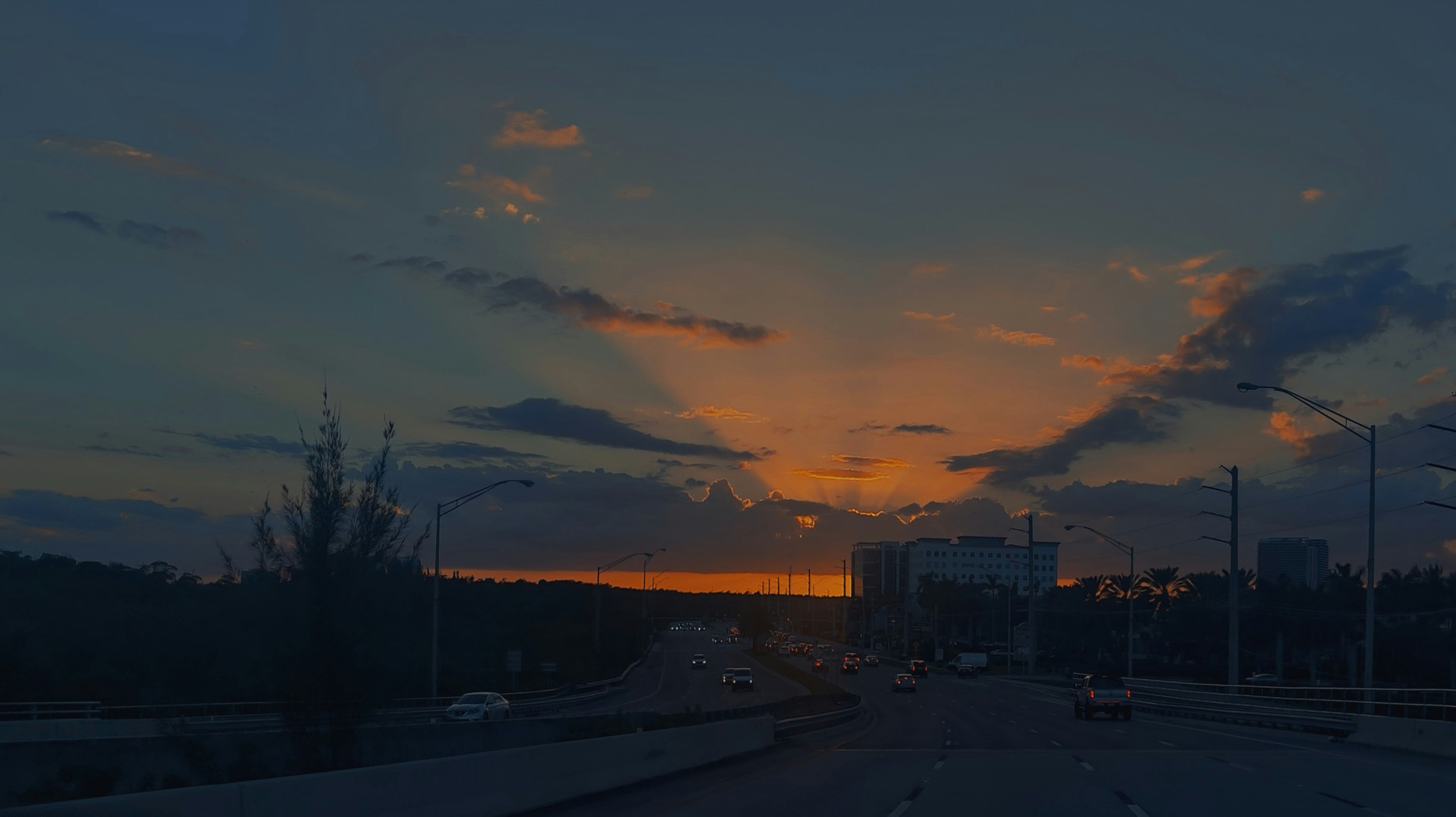 The sun is setting over a city street